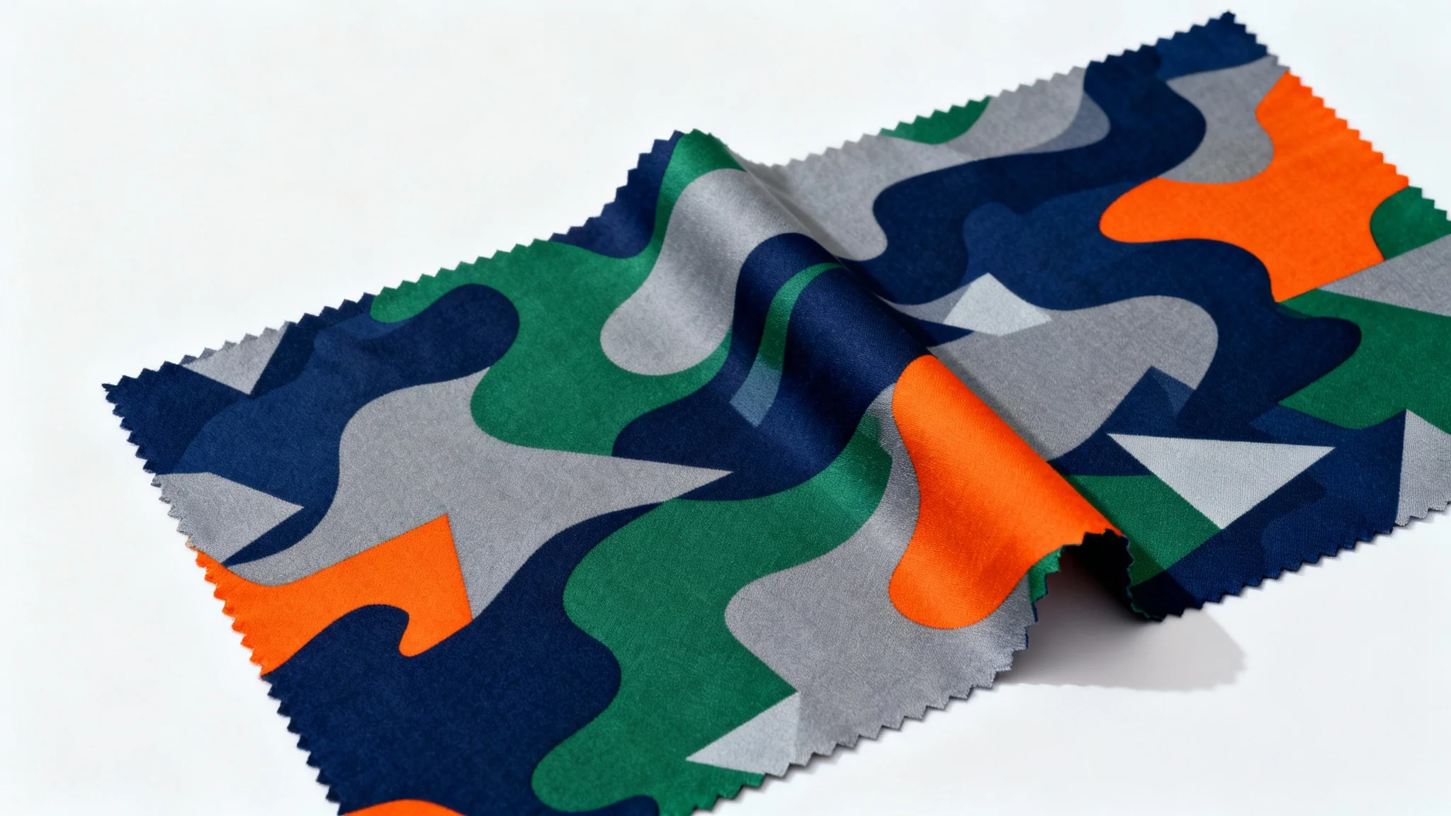 An abstract camouflage background featuring a modern pattern with a mix of organic and geometric shapes in navy blue, forest green, orange, and gray, shown against a plain white background.