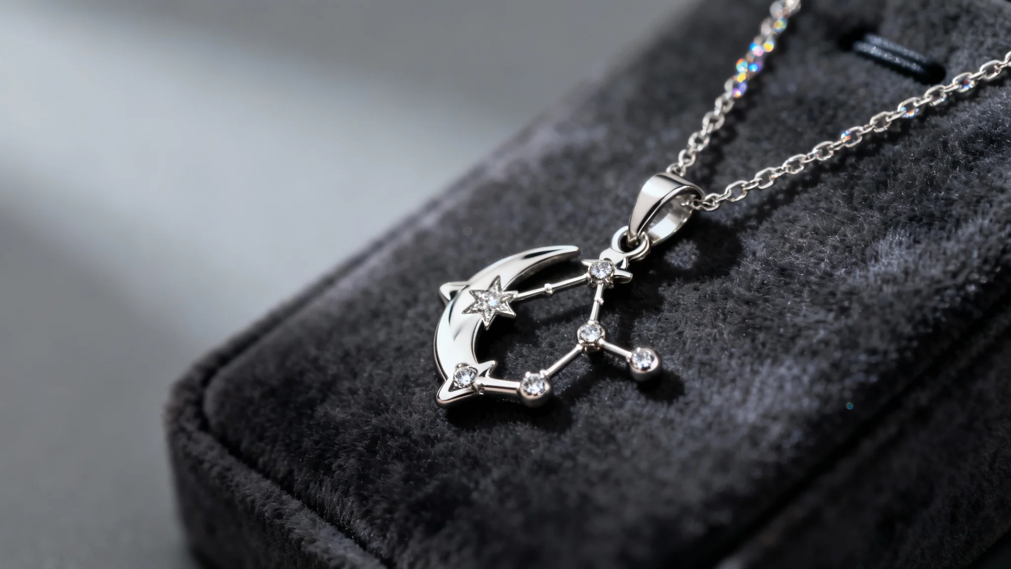 A close-up photograph of a luxurious, custom-designed platinum and diamond necklace shaped like a constellation, presented on a dark velvet background.
