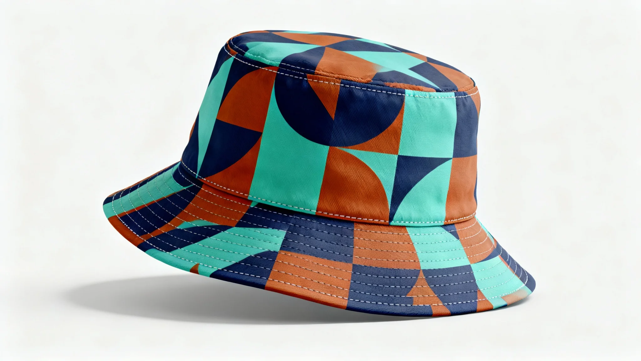 A photorealistic mockup of a modern bucket hat with a colorful abstract geometric pattern, displayed against a plain white background in a studio setting.