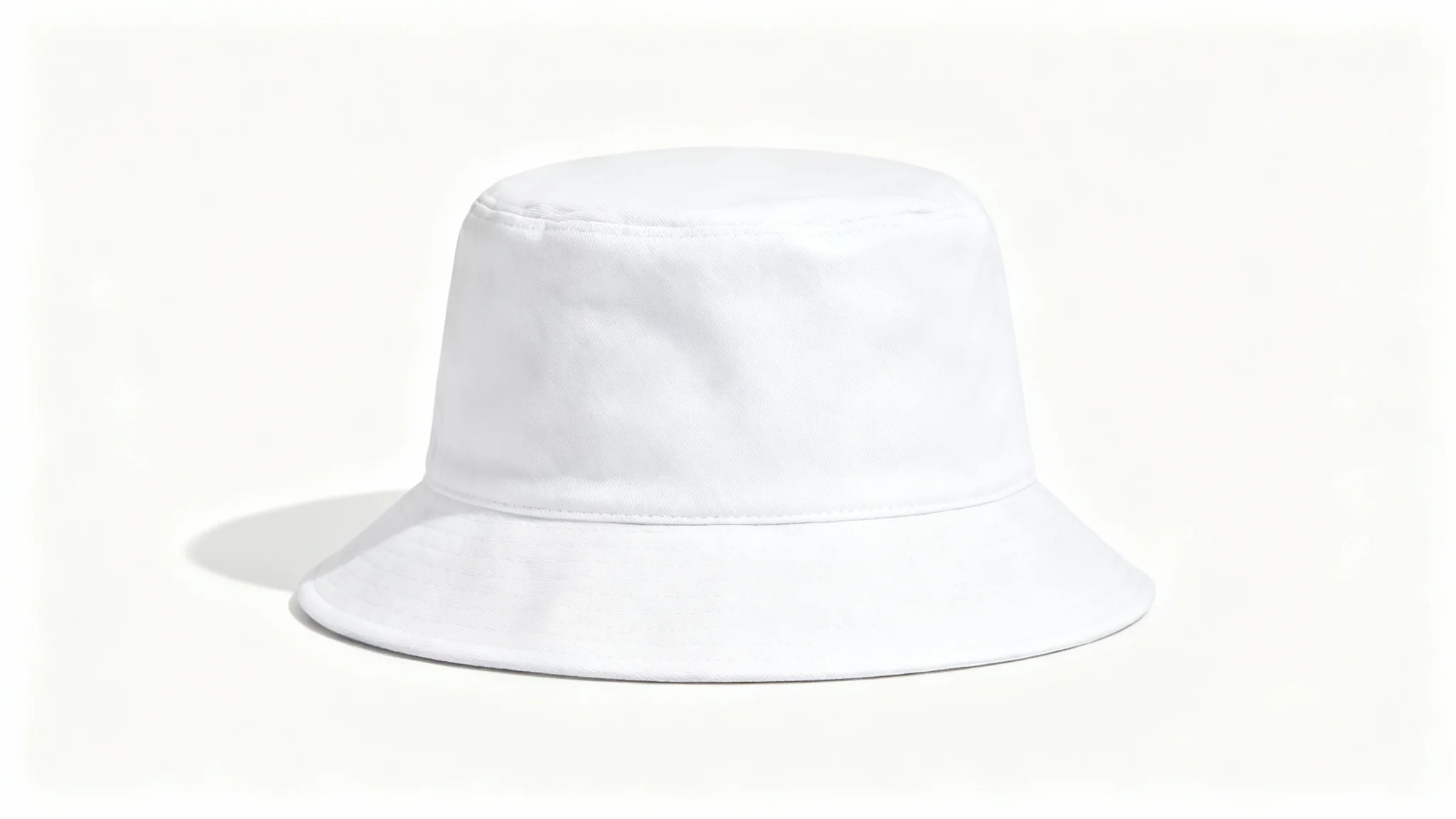 A studio product shot of a plain white bucket hat viewed from the front, set against a clean white background, serving as a mockup.