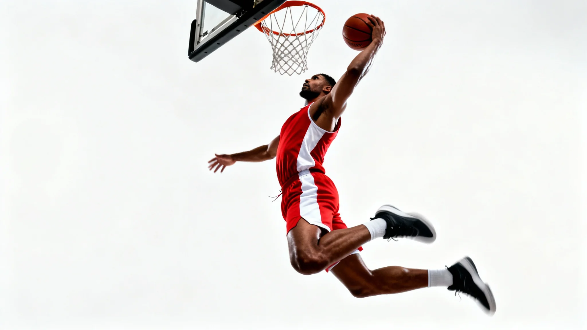 A dynamic, professionally edited photo of a basketball player in mid-air executing a powerful slam dunk against a clean white background.