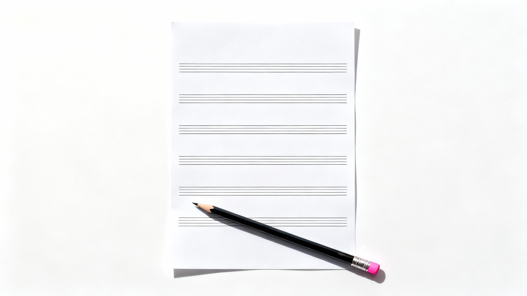 A high-quality mockup image showing a single, blank sheet of musical staff paper with a graphite pencil resting on it, set against a clean white background.
