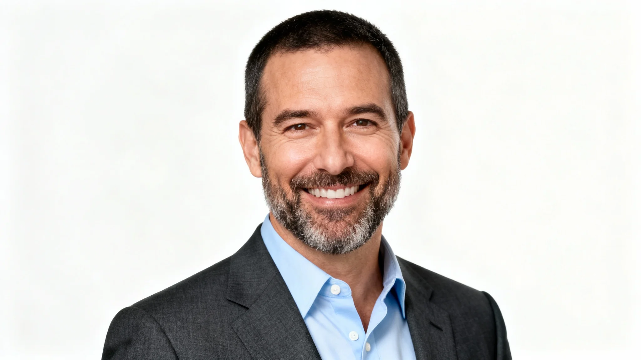 A professional, studio-quality headshot of a smiling man in a suit, looking confident and ready for business, set against a solid white background.