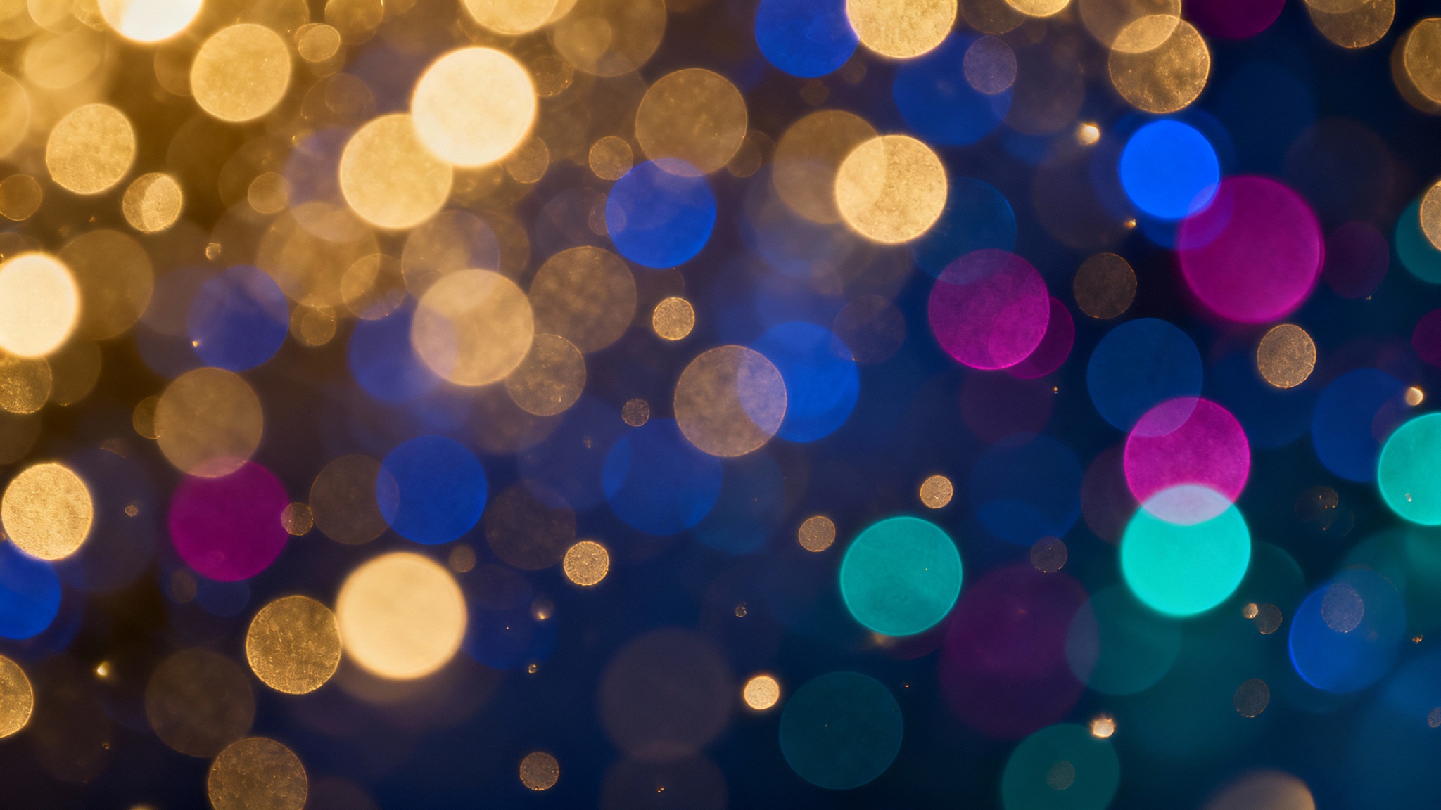 An abstract background of colorful bokeh lights, with soft, out-of-focus glowing orbs in shades of gold, blue, and magenta creating a dreamy effect.