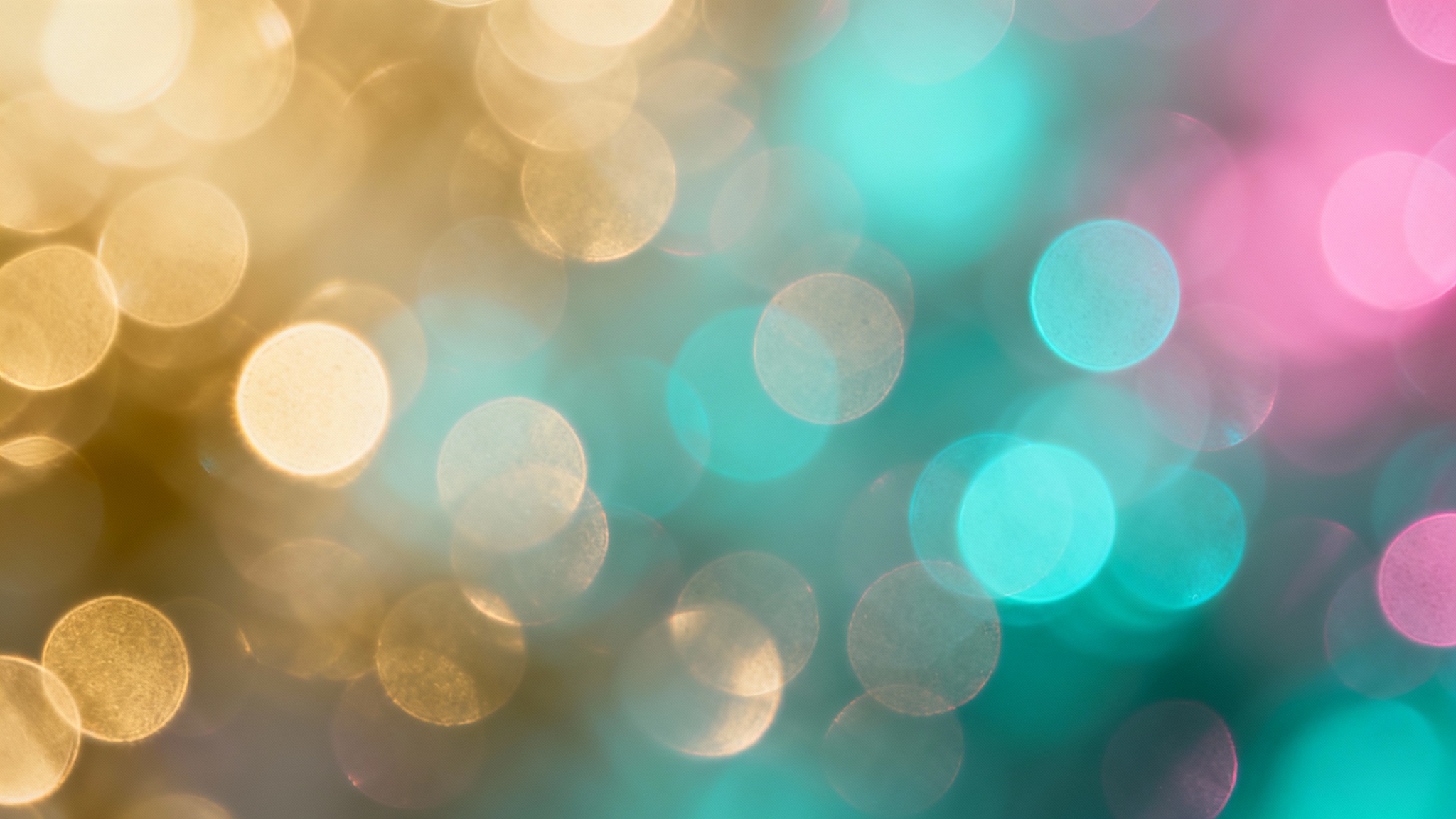A vibrant and abstract background of out-of-focus bokeh lights, featuring glowing orbs in shades of gold, turquoise, and magenta creating a dreamy effect.
