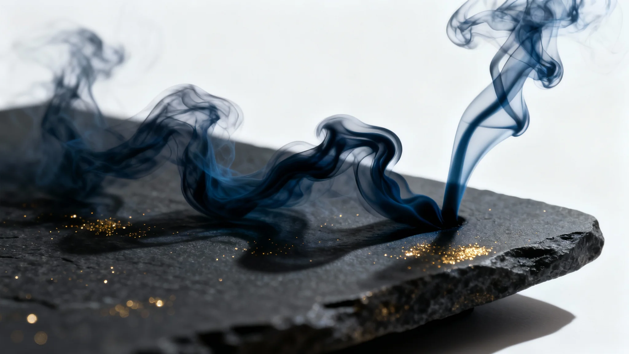 An elegant and mysterious dark background featuring wisps of charcoal-colored smoke and shimmering gold dust, creating a luxurious atmosphere for a perfume ad.
