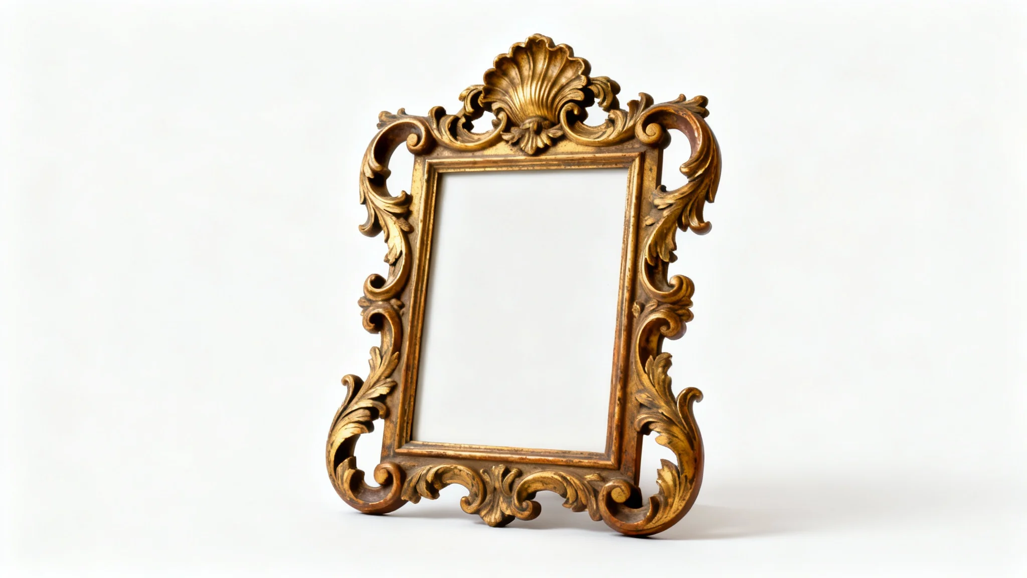 A close-up of a luxurious, gold-gilded Rococo picture frame with intricate carvings of scrolls and leaves, displayed on a pure white background.
