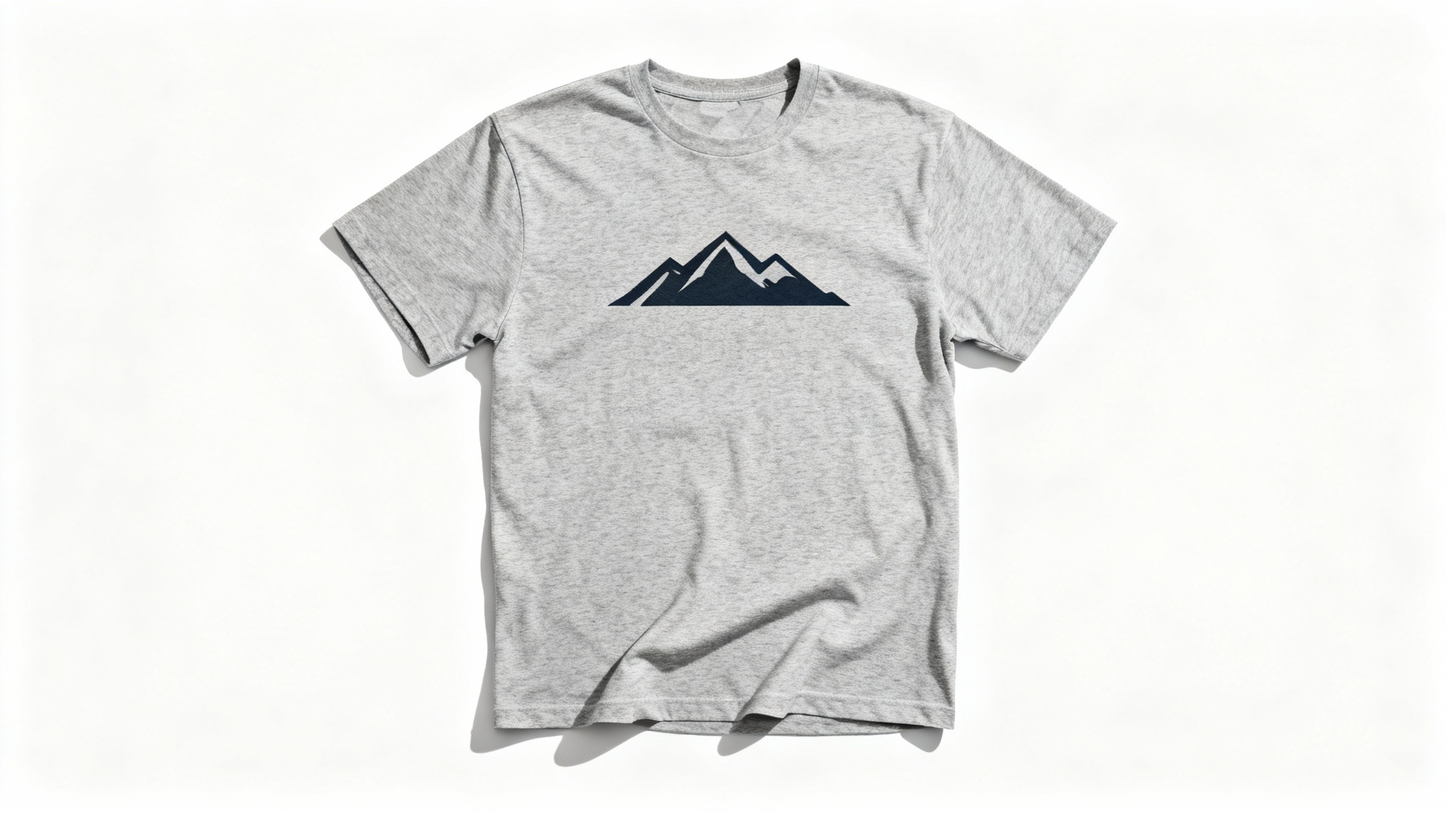 A professional product mockup of a heather gray t-shirt laid flat on a white background, featuring a minimalist mountain range graphic on the chest.