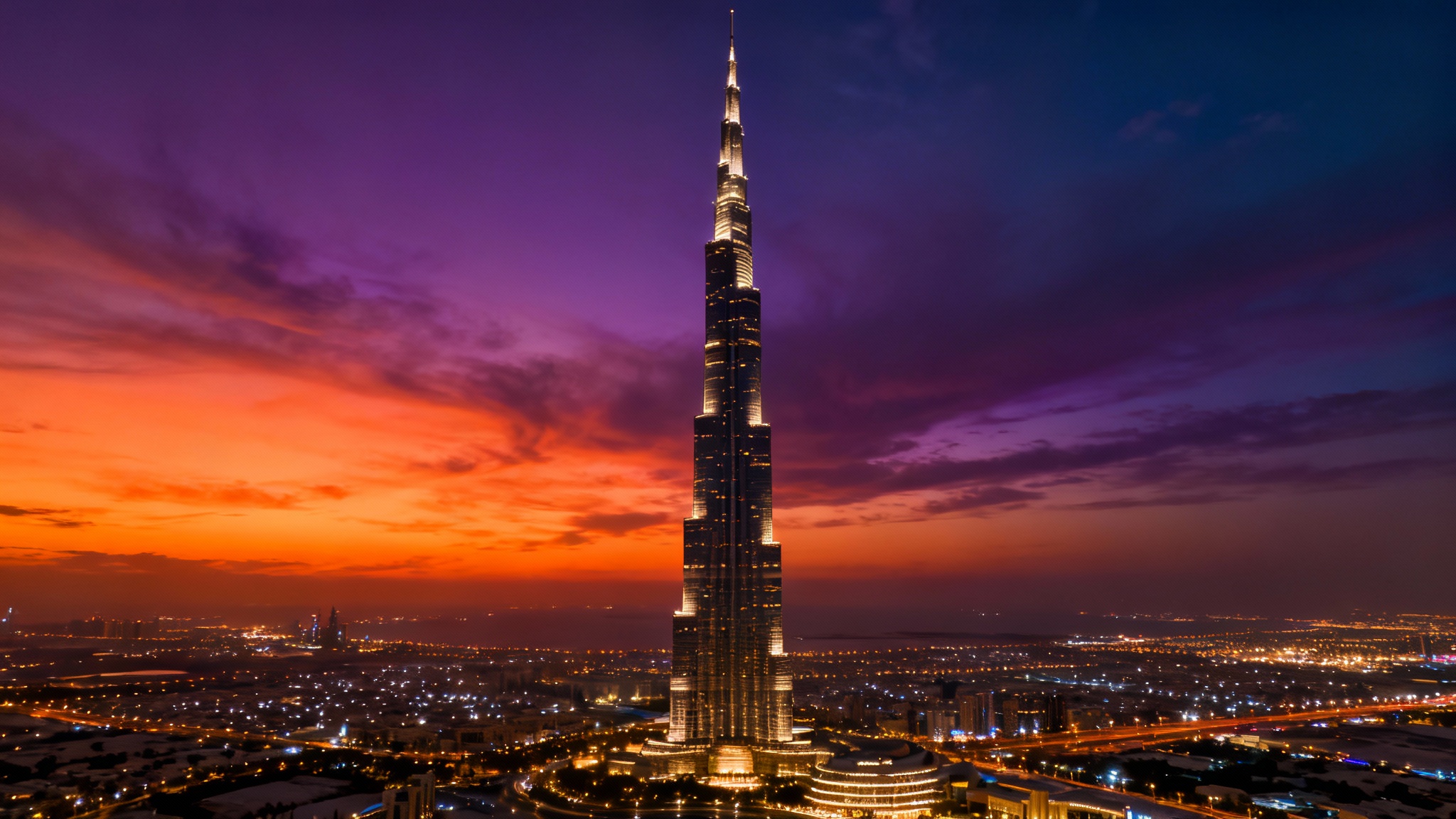 A spectacular twilight view of the Burj Khalifa and the Dubai skyline, with the sky colored in shades of orange and purple, serving as a beautiful background.