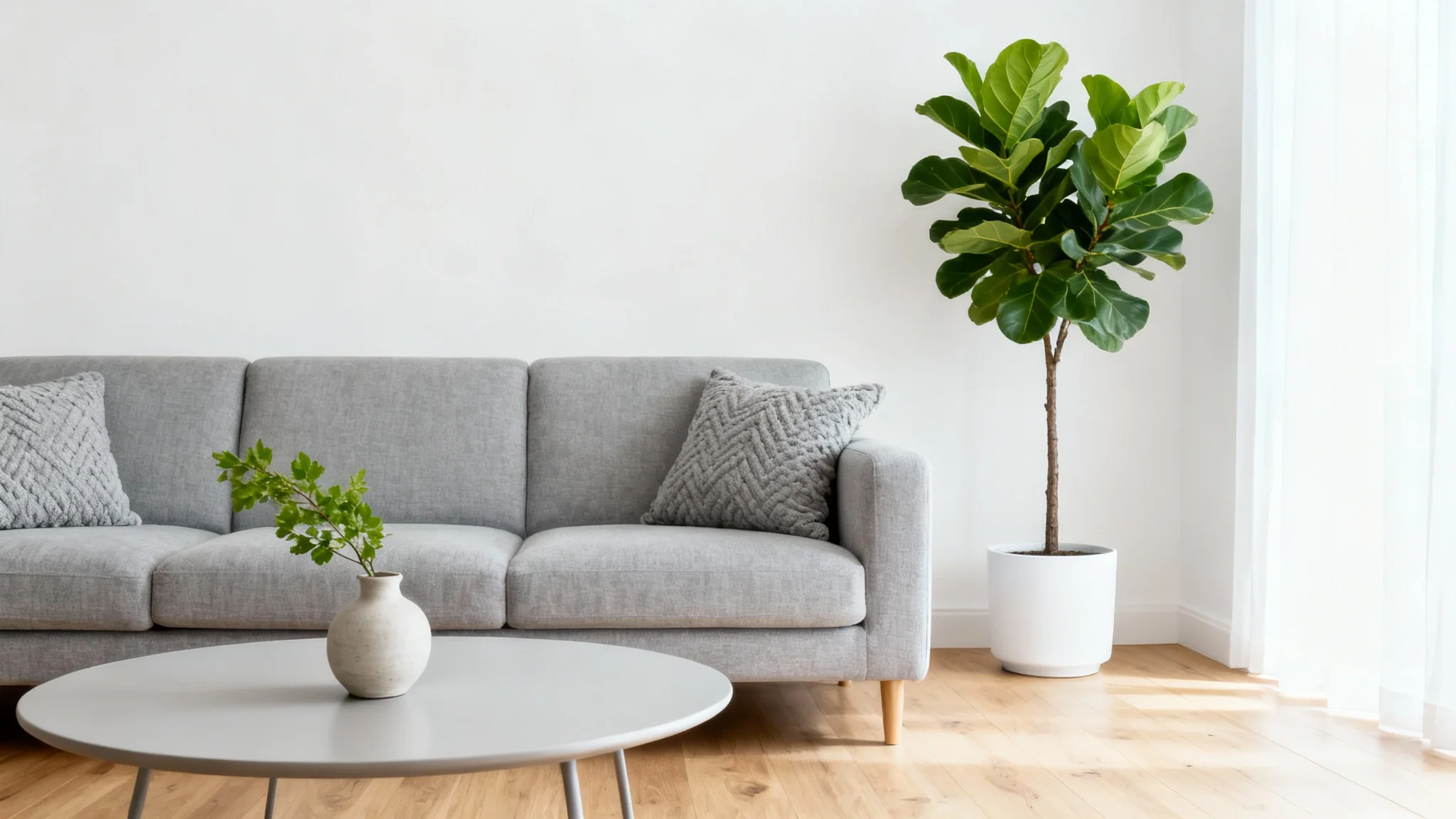 A photorealistic mockup of a beautifully redesigned modern living room with a gray sofa and a large plant, set against a clean white background.