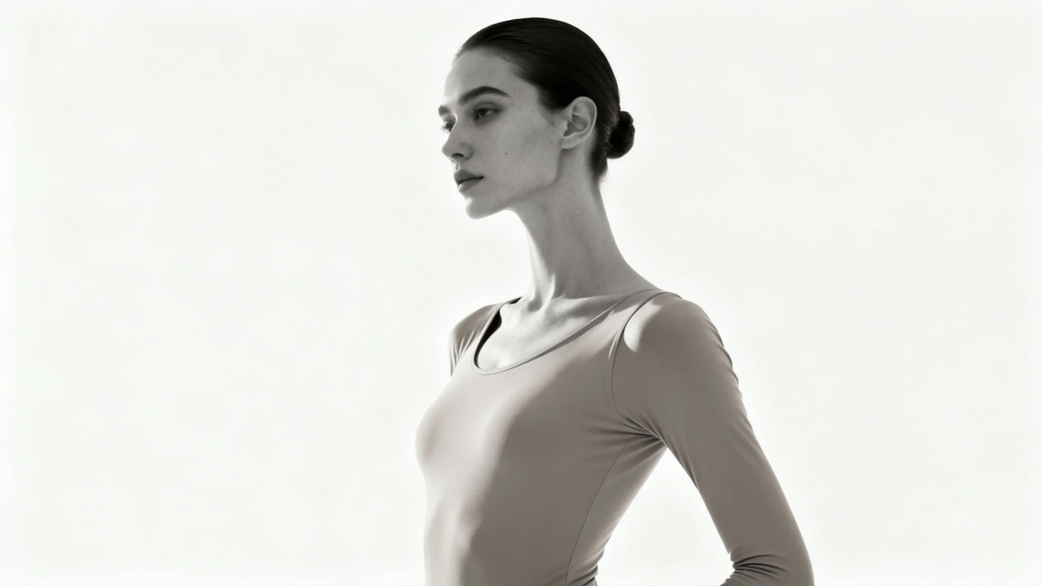 A minimalist studio photograph of a person with perfect, elegant posture standing against a clean white background, looking confident and healthy.