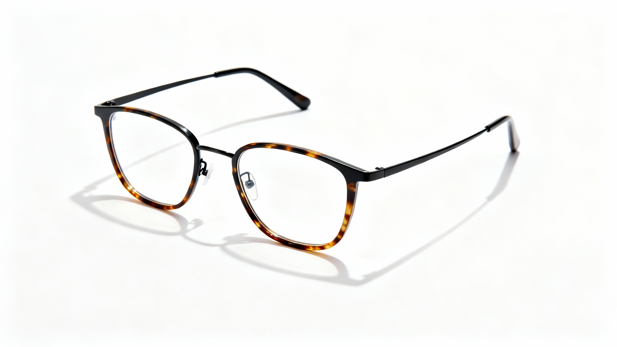 A photorealistic mockup of a pair of modern eyeglasses with a matte black metal and tortoiseshell frame, displayed on a clean white background.