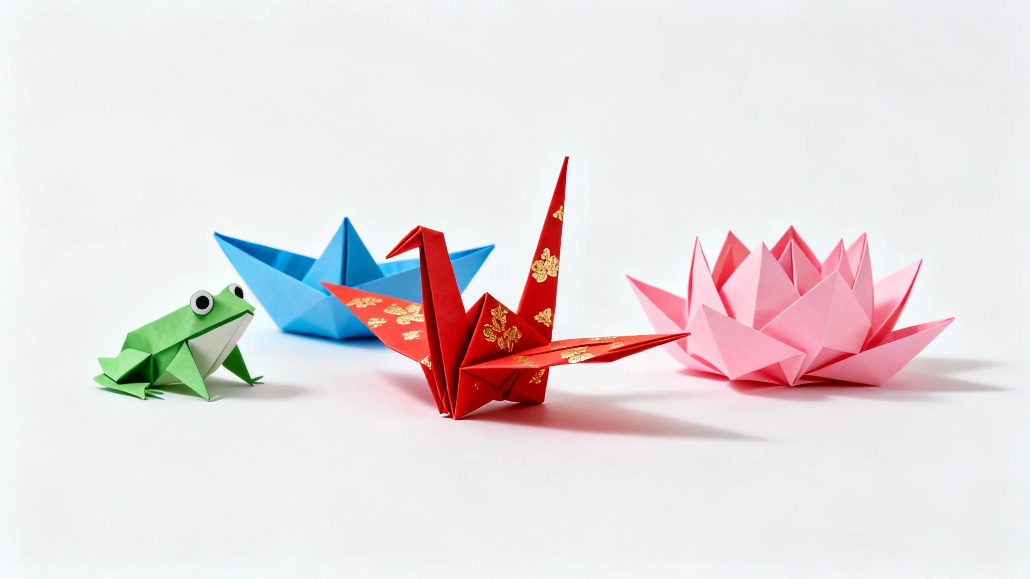 A collection of colorful and detailed origami figures, including a crane, a frog, a boat, and a lotus flower, displayed on a clean white background.