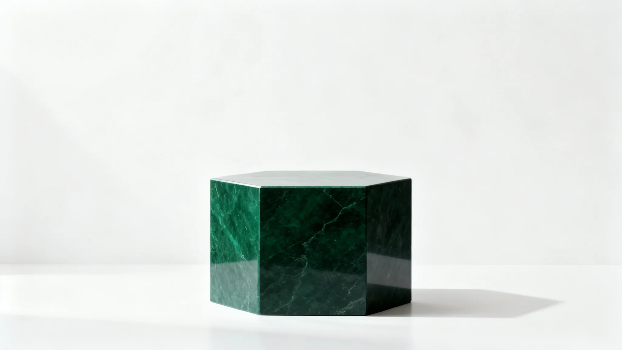 A photorealistic mockup of a dark green, hexagonal stone product pedestal, shot in a minimalist studio with a pure white background, conveying a sense of luxury and modern design.