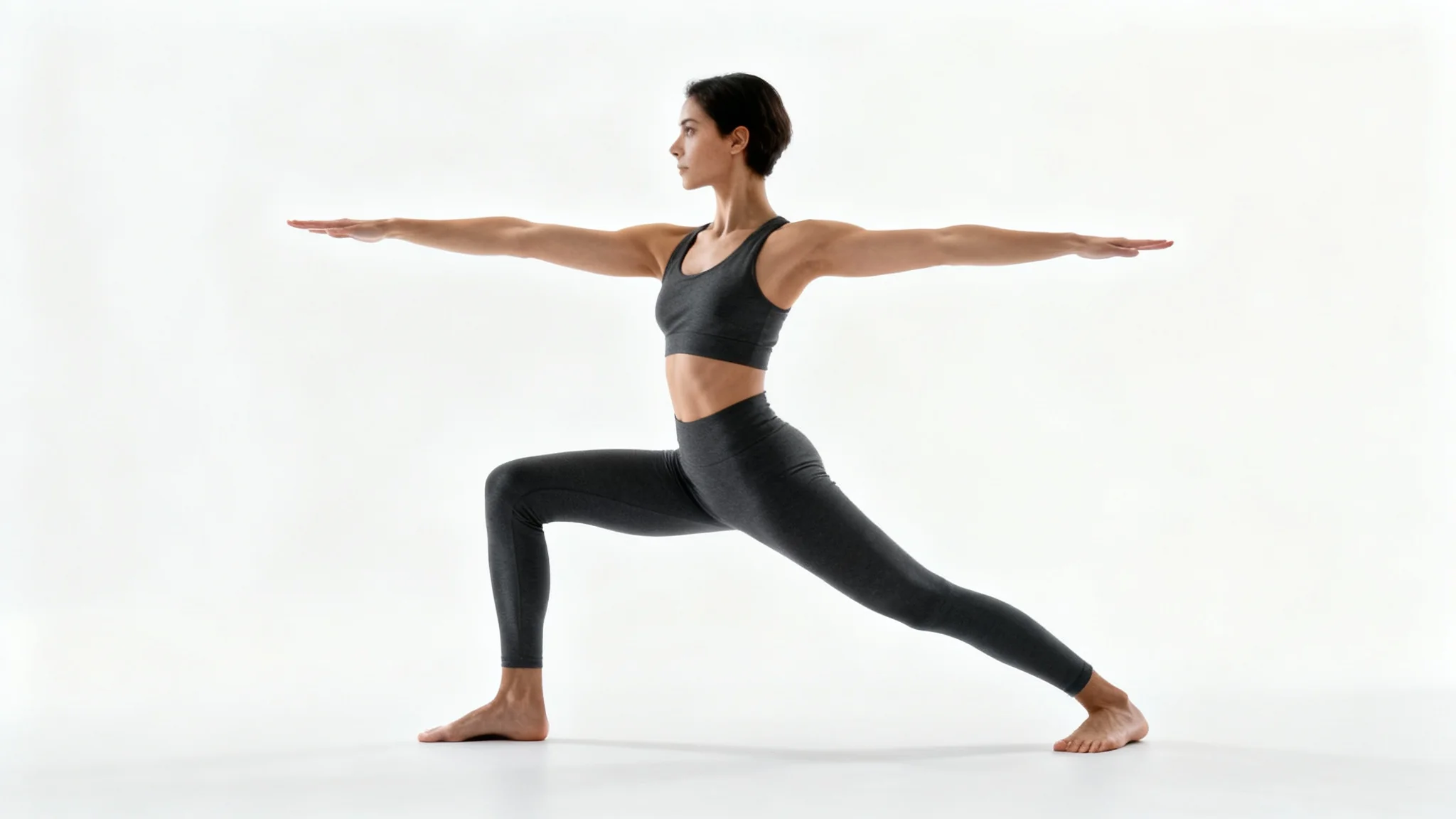 A clear, full-body reference image of a person performing the Warrior II yoga pose against a stark white background, showcasing proper form and alignment.