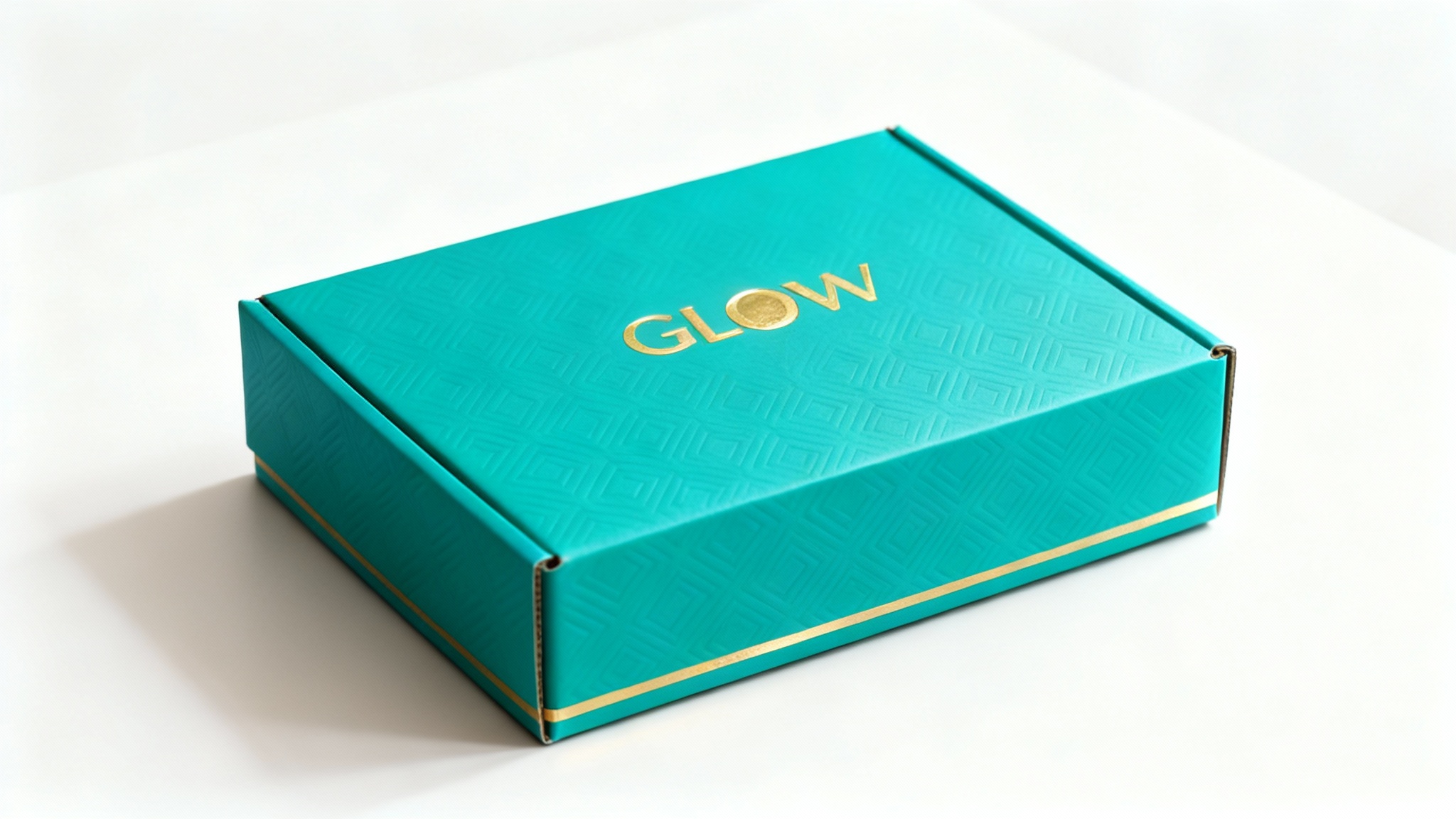 A professional hero shot of a luxury subscription box in vibrant teal with a geometric pattern and gold foil accents, featuring the logo 'GLOW' on the lid.