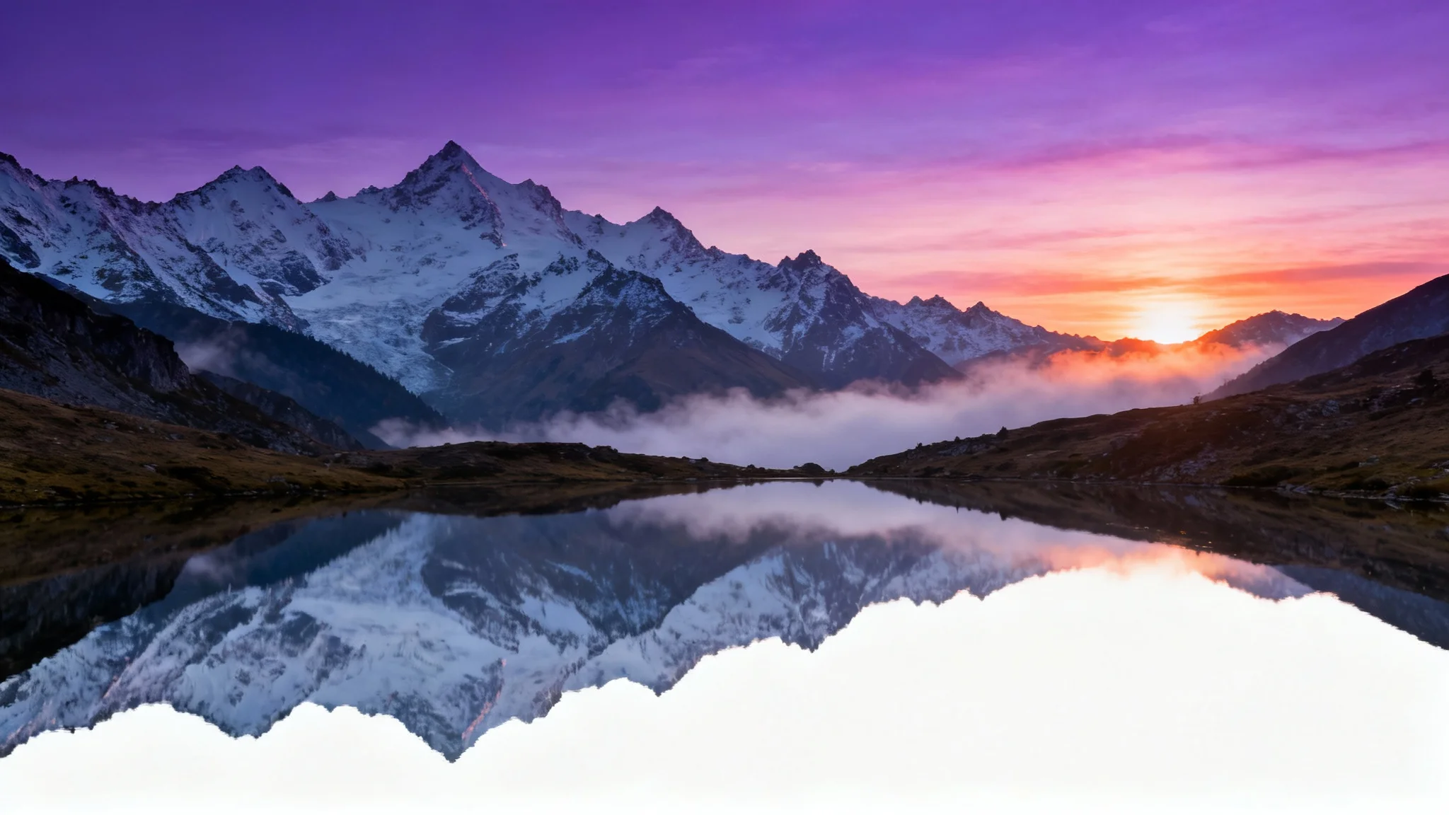 A serene 16:9 desktop wallpaper showing a majestic, snow-capped mountain reflected in a clear lake at sunrise.