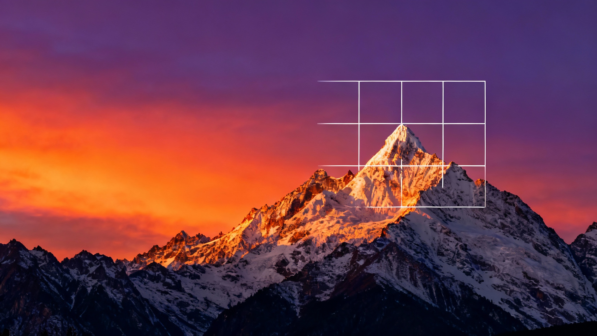 A beautiful mountain landscape at sunset with a semi-transparent 3x3 grid overlay, demonstrating a compositional tool.