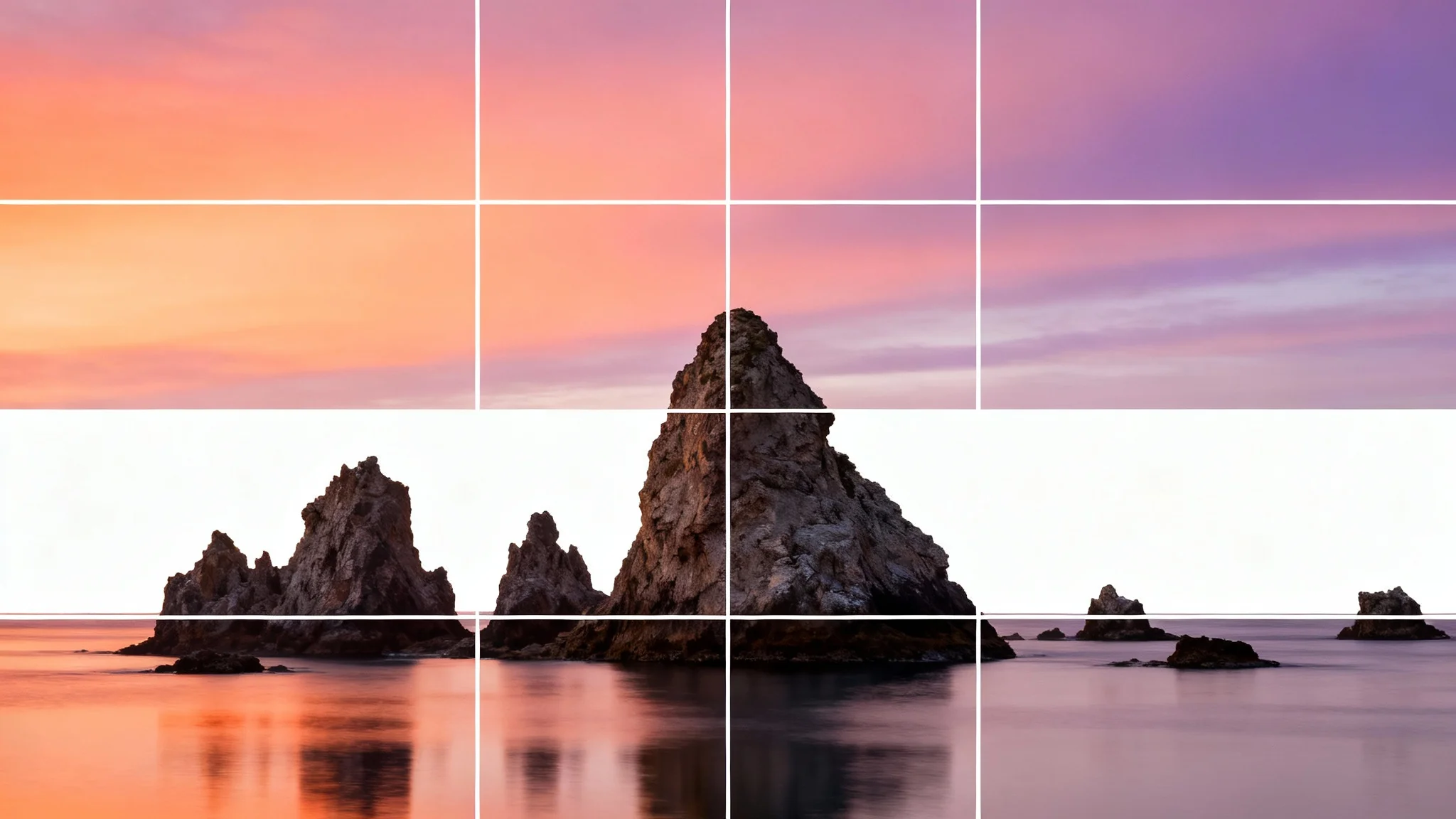 A dramatic coastal landscape at sunrise with a white 3x3 grid overlay, demonstrating the rule of thirds for photographic composition.