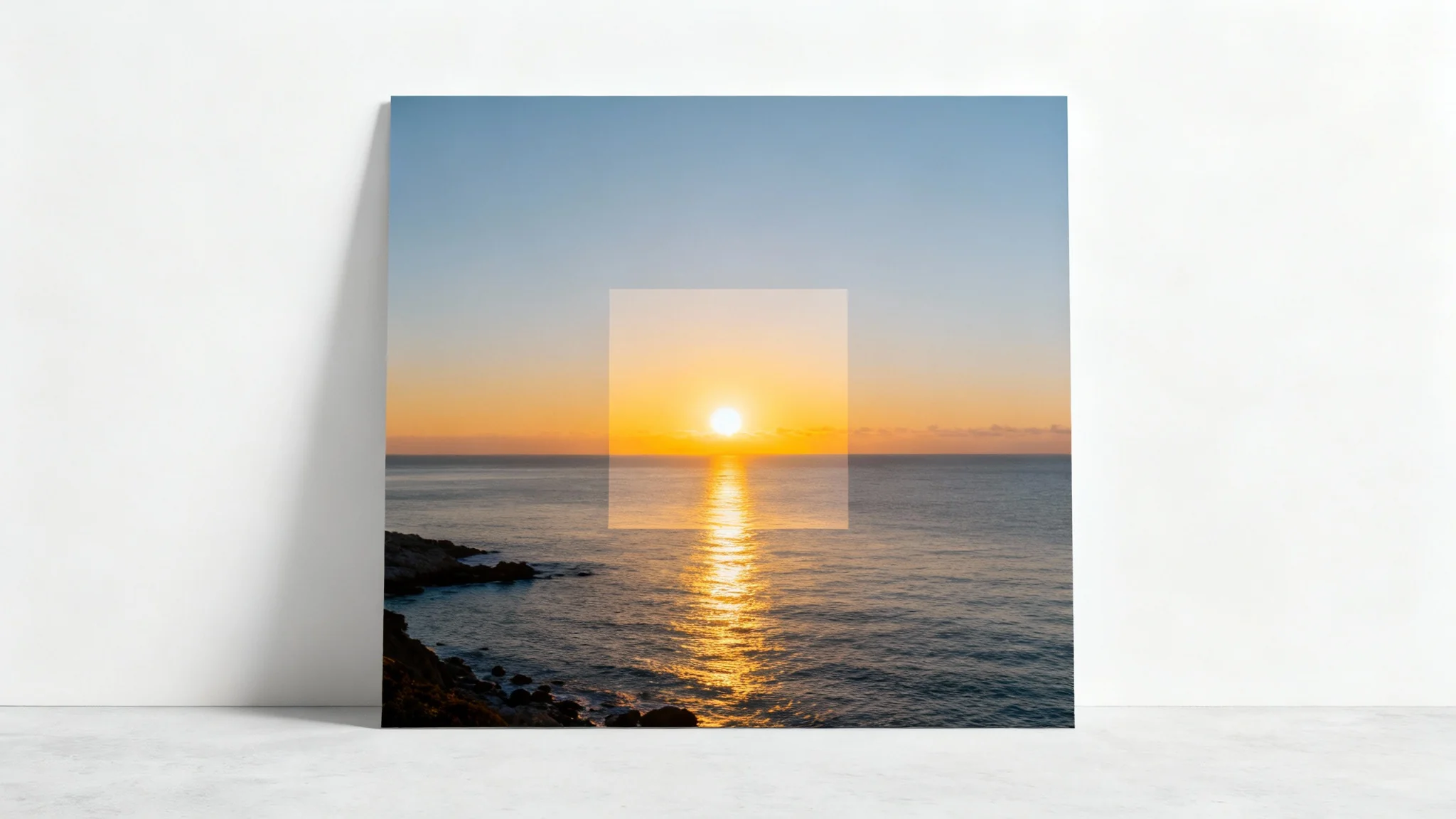 A conceptual image illustrating a square crop. A rectangular photo of a coastal sunrise has a vibrant, focused square section in the middle, while the outer parts of the rectangle are faded, demonstrating the cropping process.