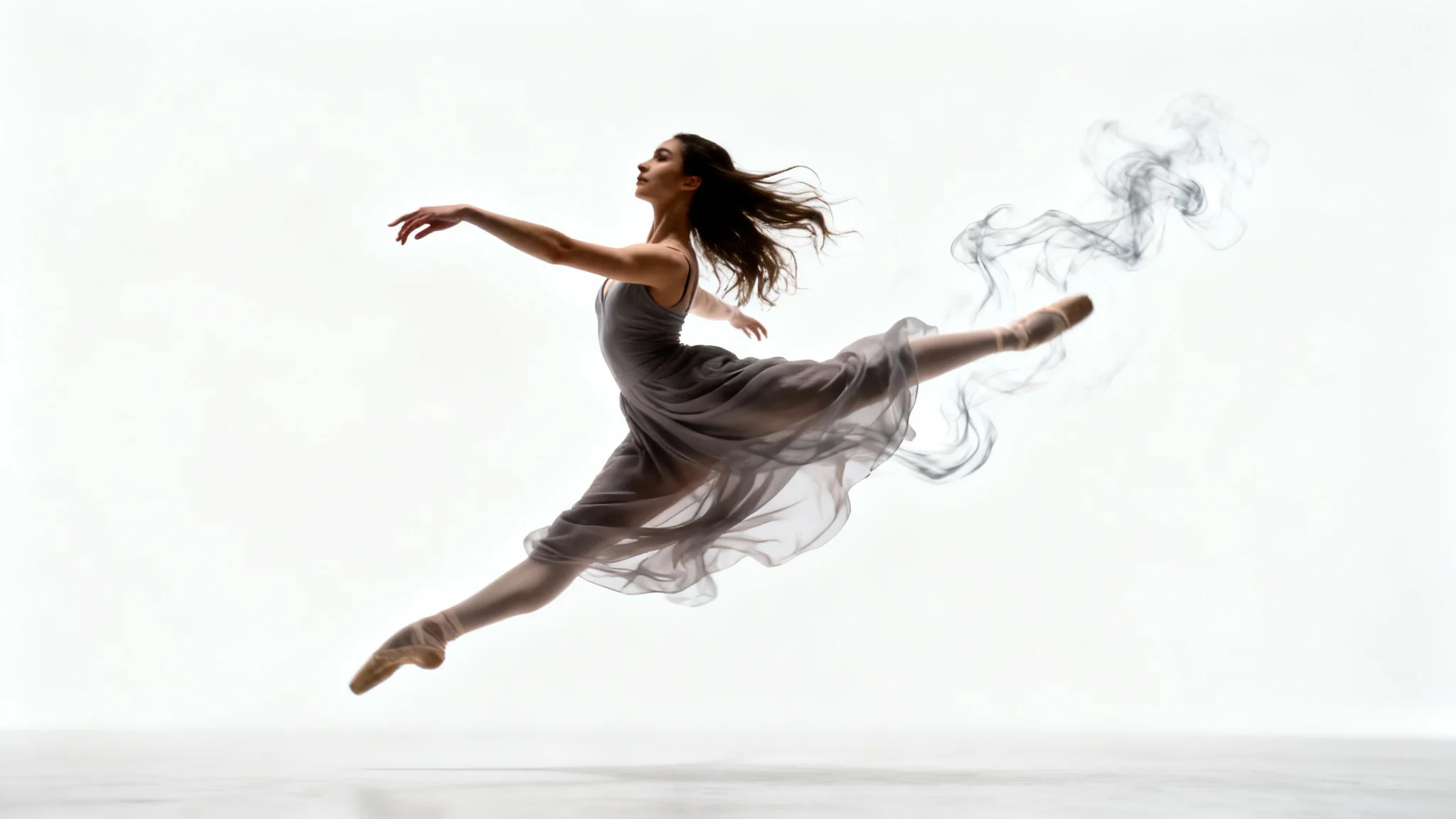 A photorealistic image of a ballet dancer in mid-air against a white background. The dancer is in sharp focus, but her dress and hair are blurred to create a sense of motion, illustrating a 'moving photo' effect.