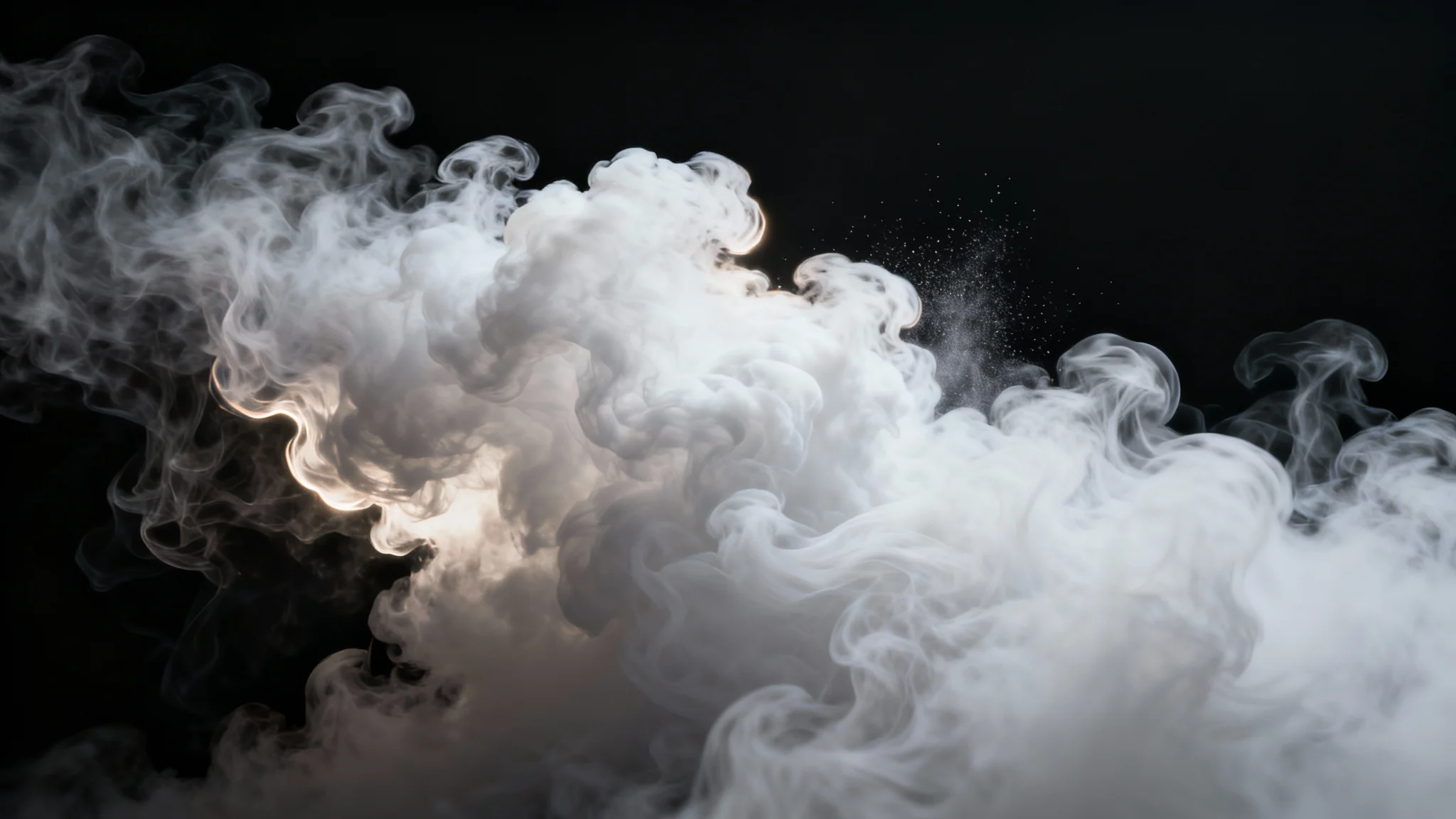 A dramatic, high-resolution image of a thick plume of white smoke swirling gracefully against a solid black background, illuminated to show its texture.