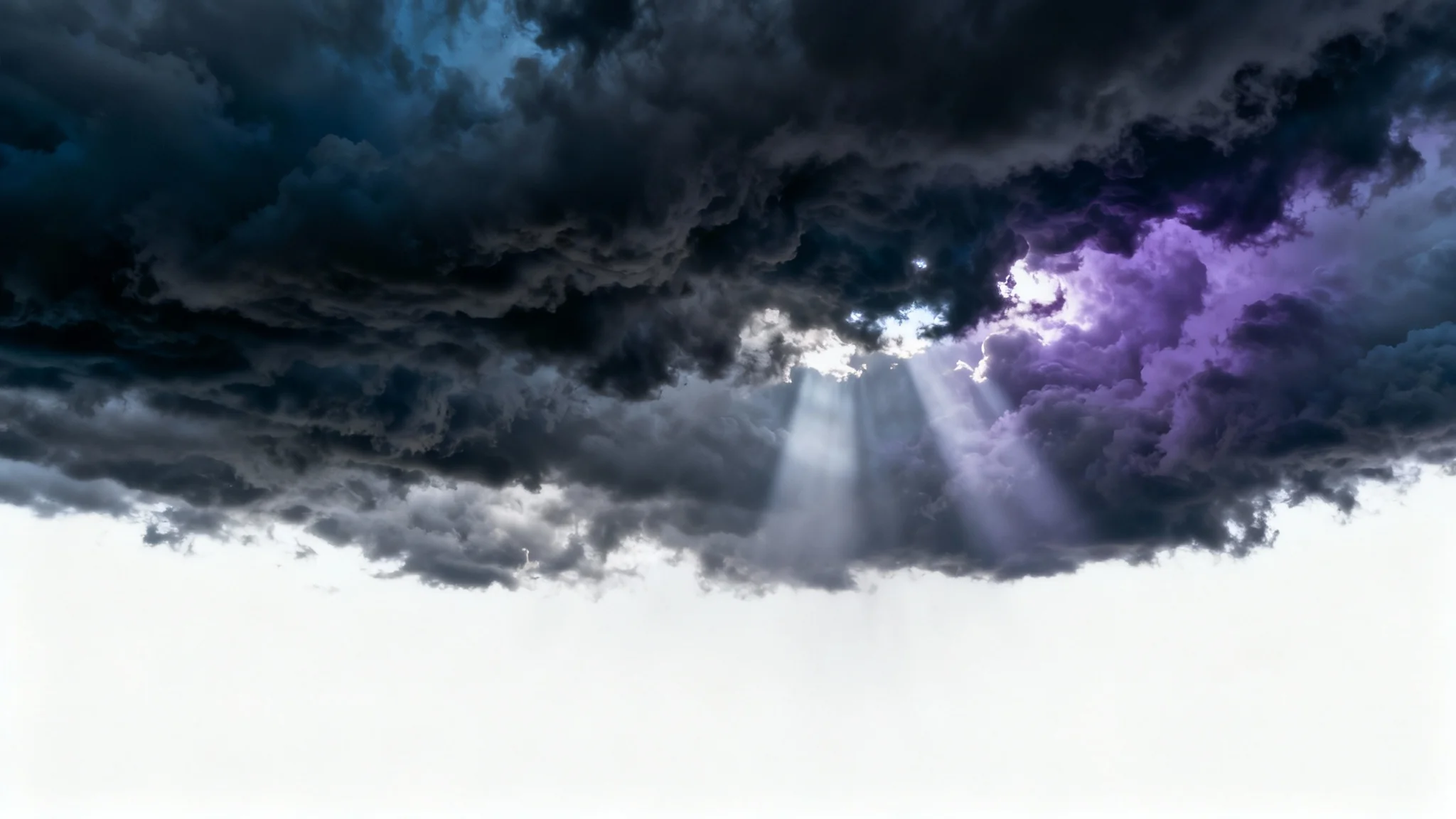 A dramatic and moody background image of dark, turbulent storm clouds filling the sky, with rays of light breaking through them.
