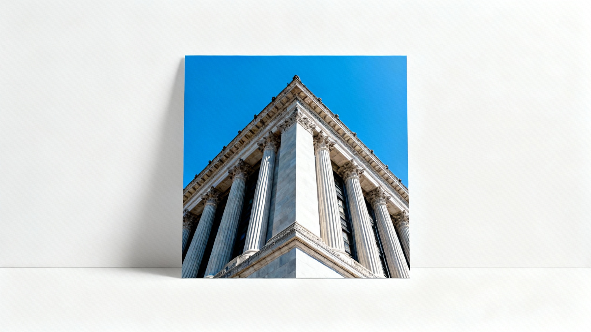 A skewed photograph of a tall classical building, taken from a low angle, causing visible perspective distortion. The photo is displayed against a plain white background.