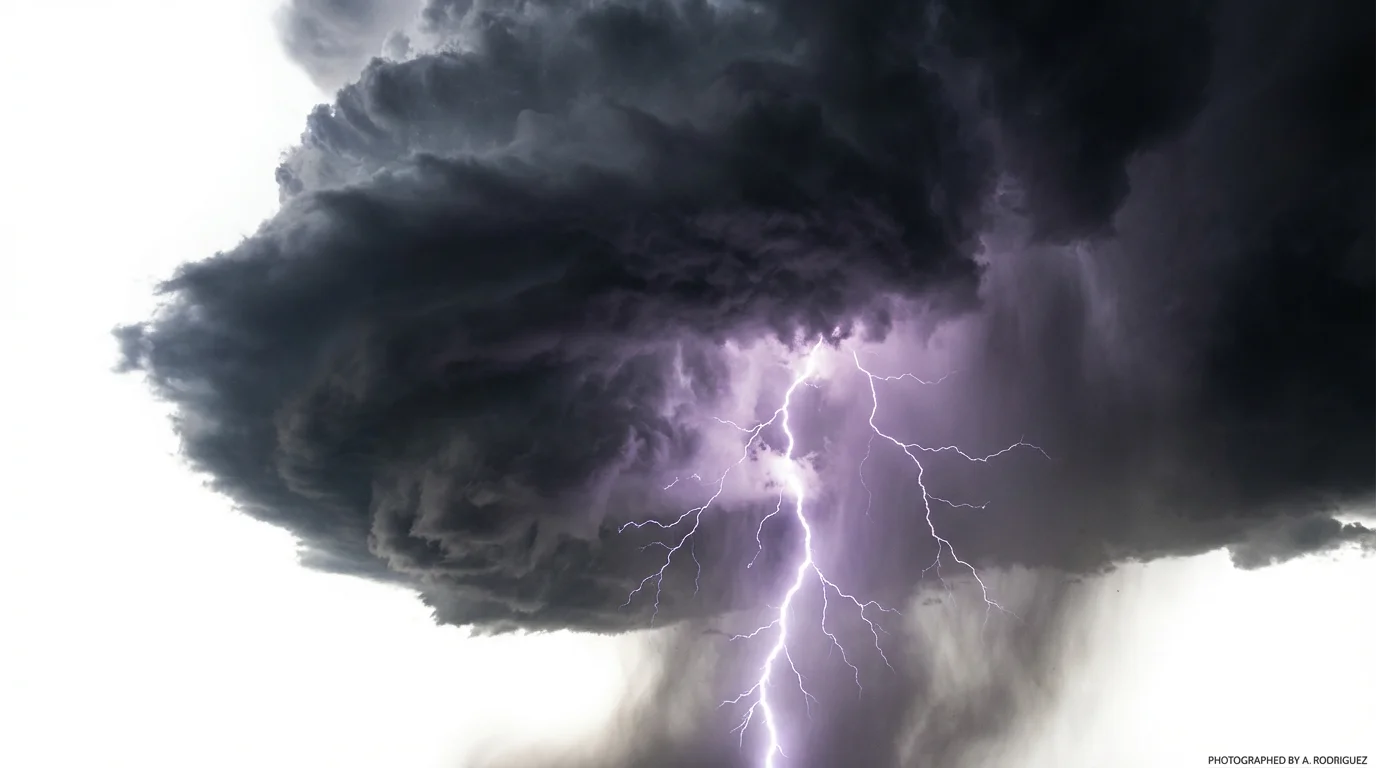 A dramatic depiction of a thunder video effect, showcasing a massive, dark storm cloud with a powerful purple and white lightning bolt striking downwards, all isolated against a clean white background.
