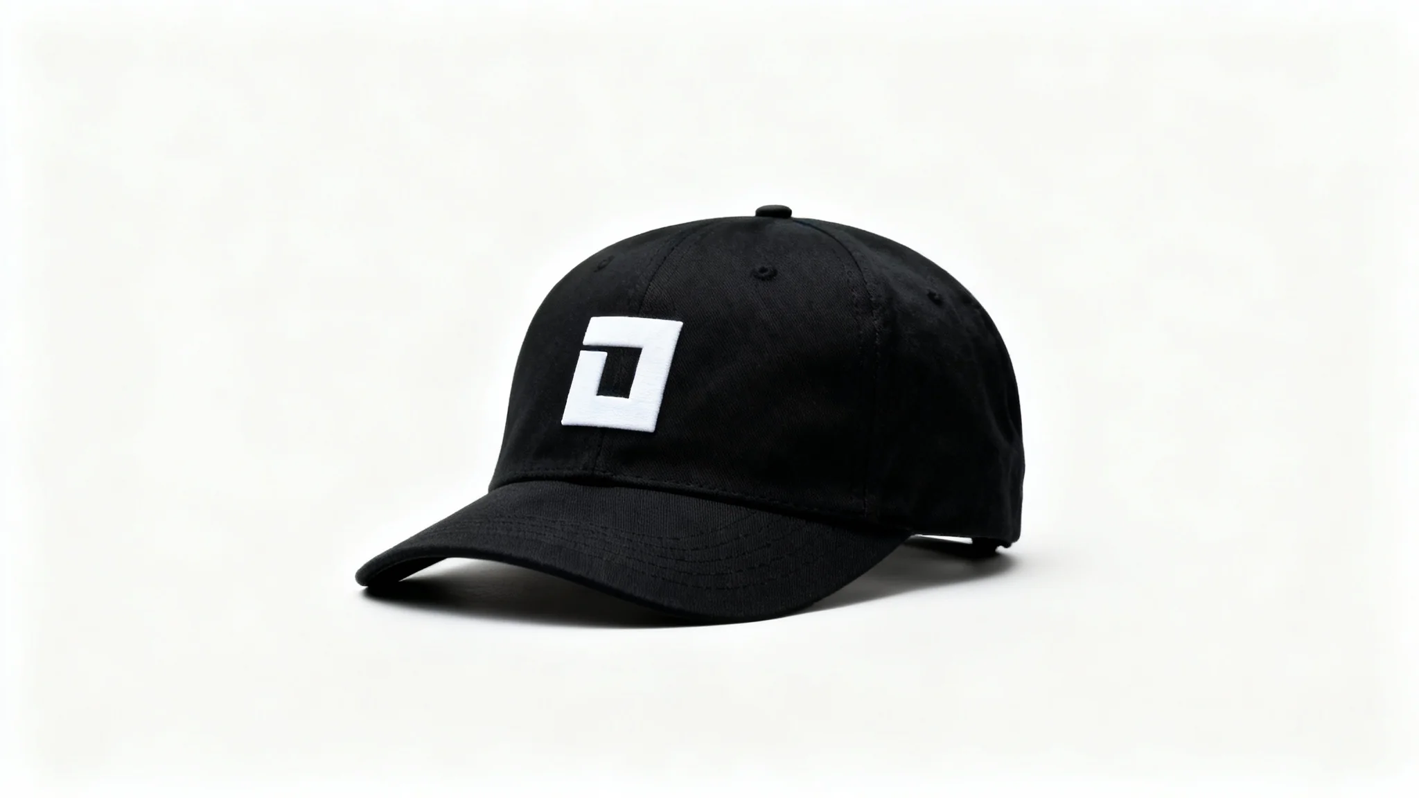 A photorealistic mockup of a black snapback cap with a minimalist white geometric logo embroidered on the front, set against a clean white background.