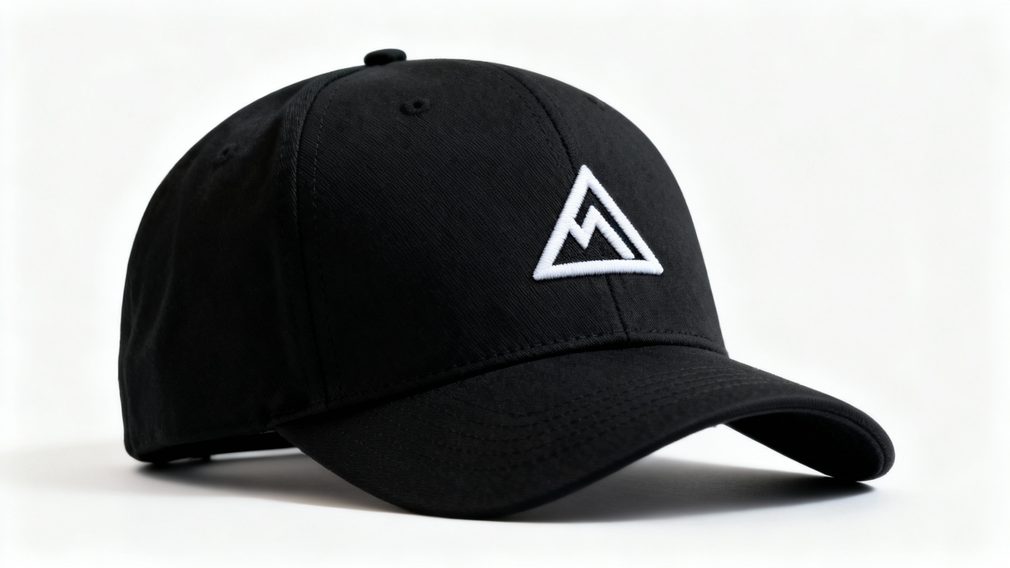 A photorealistic mockup of a black snapback cap with a white geometric mountain logo embroidered on the front, set against a clean white background.