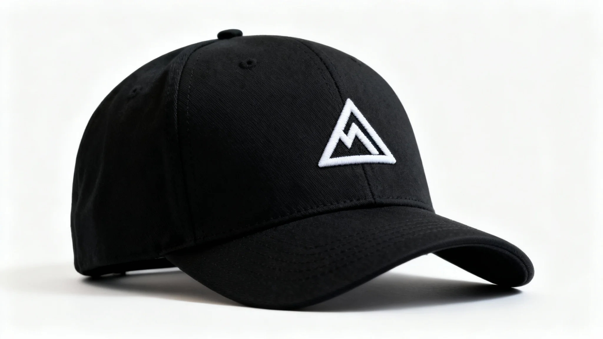 A photorealistic mockup of a black snapback cap with a white geometric mountain logo embroidered on the front, set against a clean white background.
