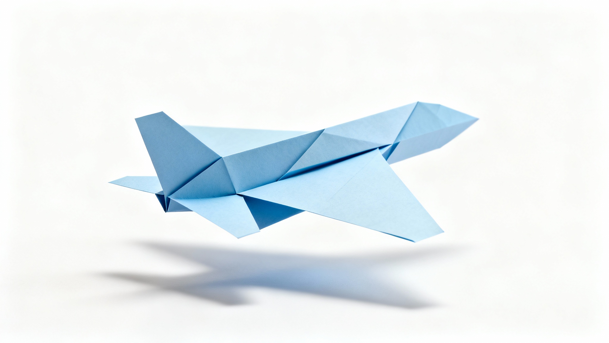 A photorealistic mockup of a light blue paper cutout of a commercial airplane, floating against a solid white background with a soft shadow.