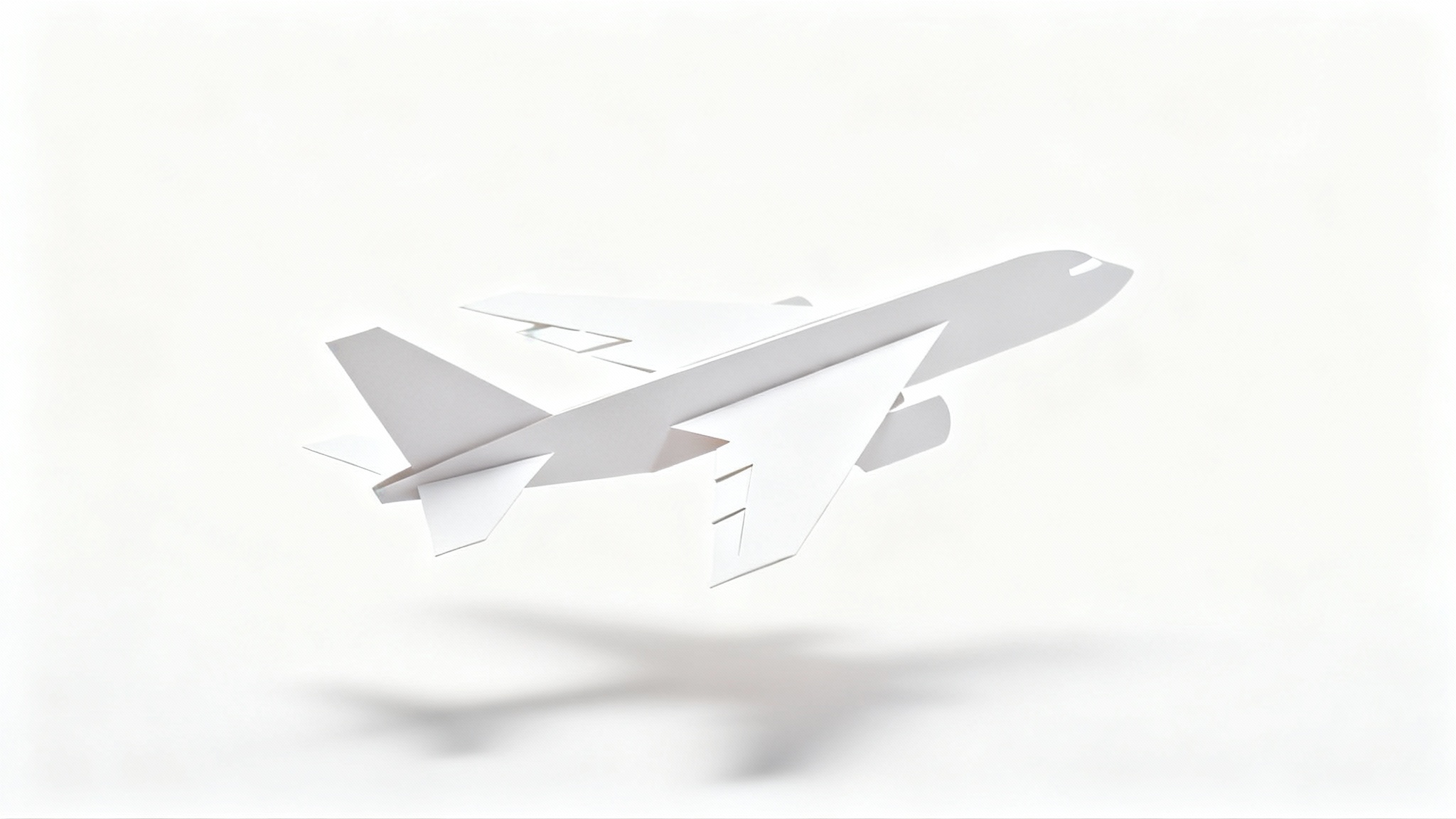 A precisely cut paper model of a passenger airplane, made from white cardstock, shown against a clean white background with a gentle shadow.