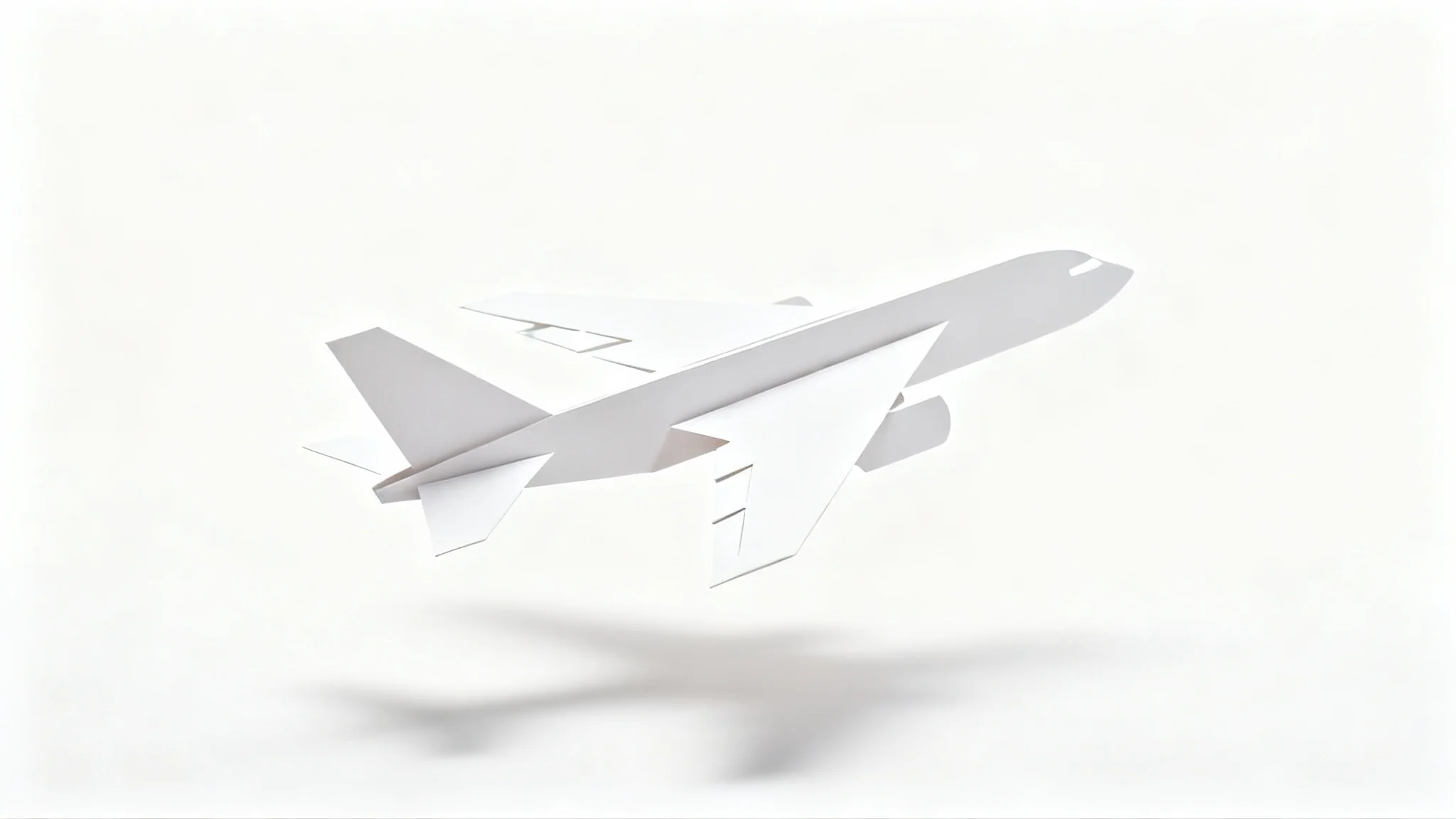 A precisely cut paper model of a passenger airplane, made from white cardstock, shown against a clean white background with a gentle shadow.