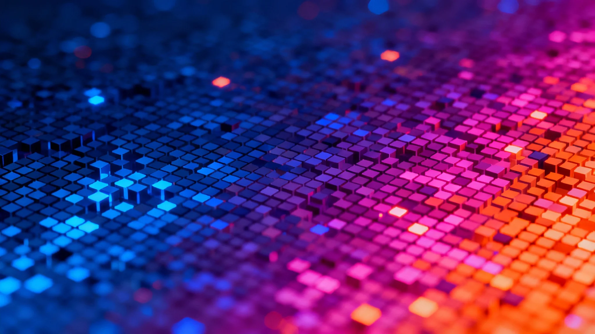 A close-up view of a digital pixel background, showing a vibrant gradient of glowing blue, purple, and orange squares.