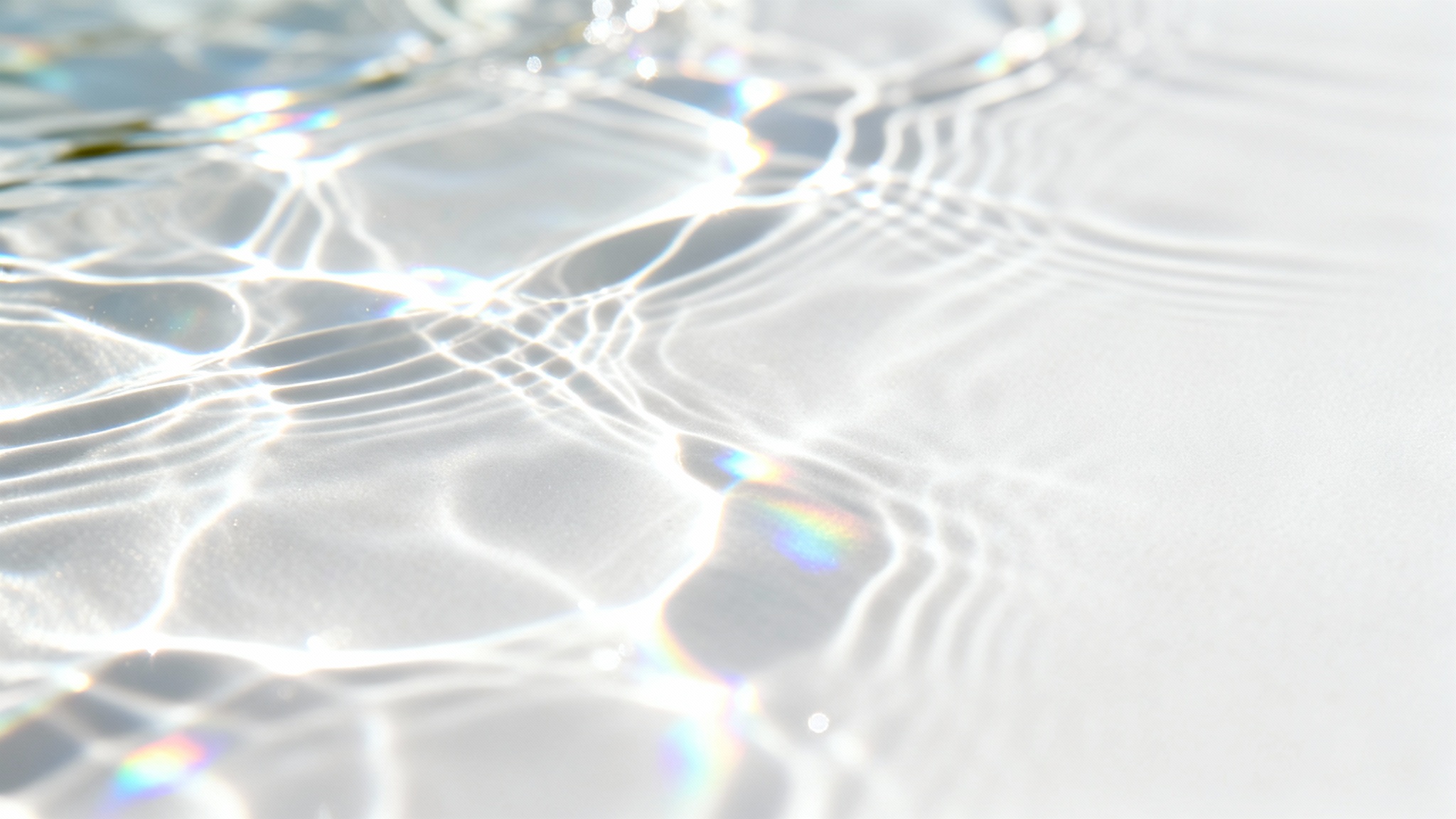 A minimalist image displaying a realistic caustics overlay effect on a clean white surface, with shimmering, water-like patterns of light creating a serene and ethereal feel.