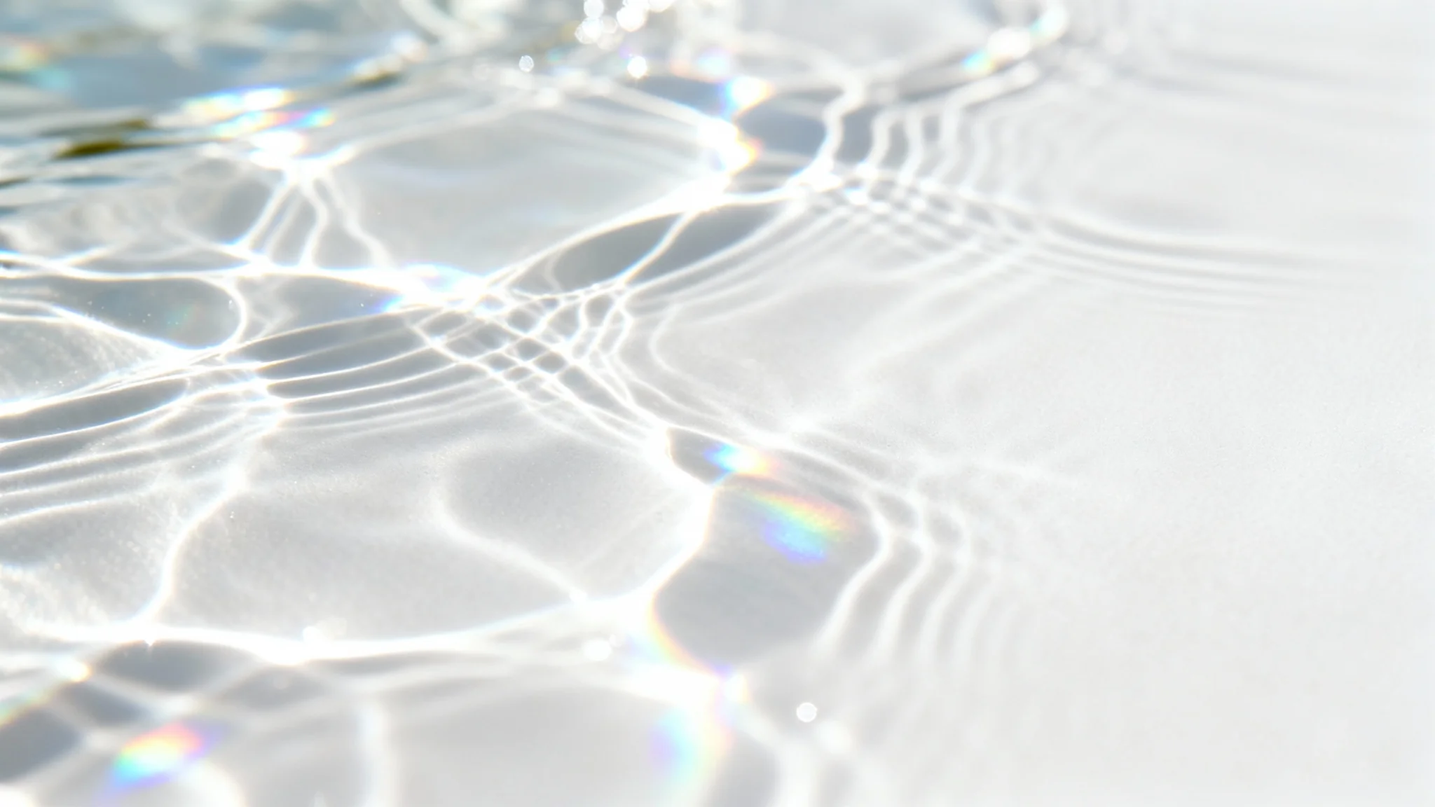 A minimalist image displaying a realistic caustics overlay effect on a clean white surface, with shimmering, water-like patterns of light creating a serene and ethereal feel.