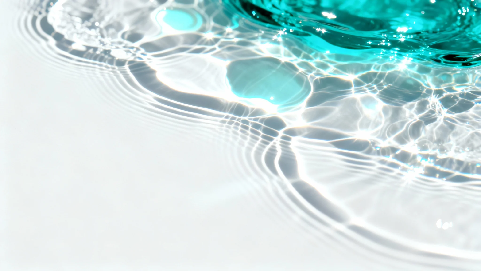 An abstract image of a caustics overlay, featuring shimmering patterns of cyan and white light on a clean white background, mimicking the effect of sunlight refracting through water.