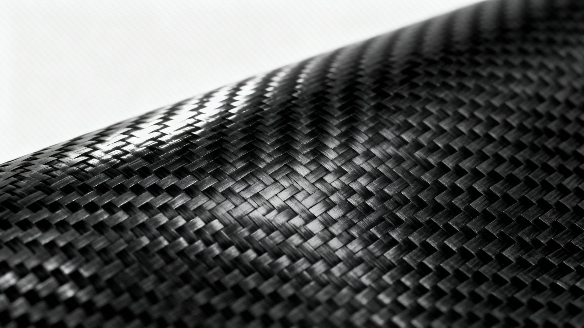 A detailed, high-resolution image of a black carbon fiber texture, showing its characteristic woven pattern with a glossy finish against a plain white background.