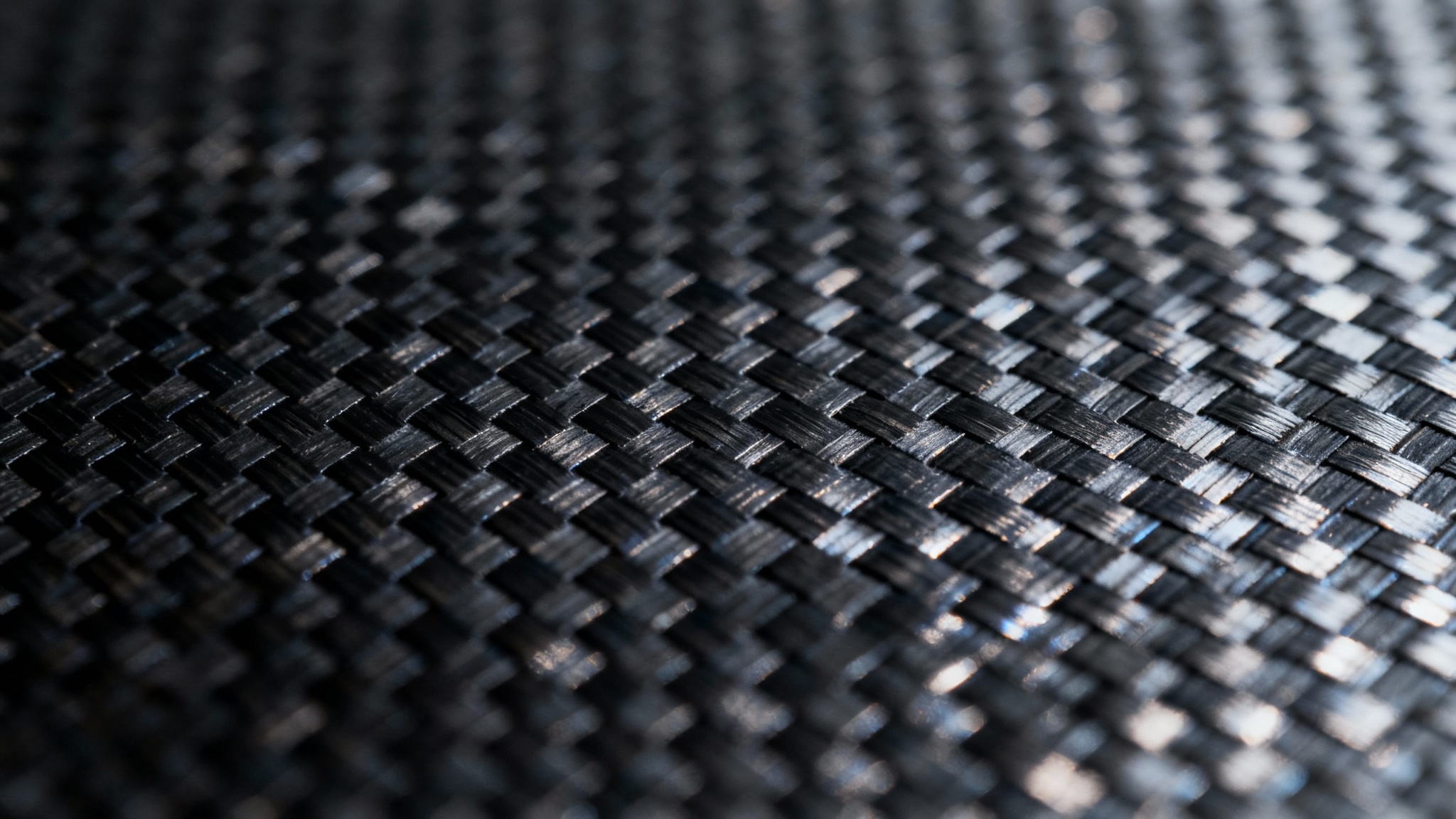 A close-up, detailed view of a black carbon fiber background, showing its intricate woven texture and glossy finish.