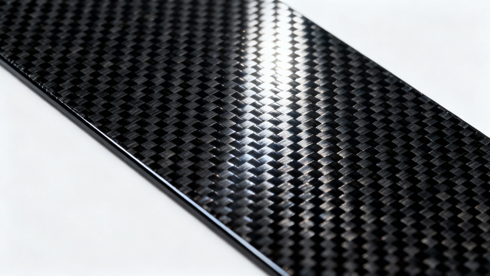 A detailed, close-up shot of a black carbon fiber texture, showcasing its intricate weave pattern and glossy finish under a sharp light, isolated on a white background.