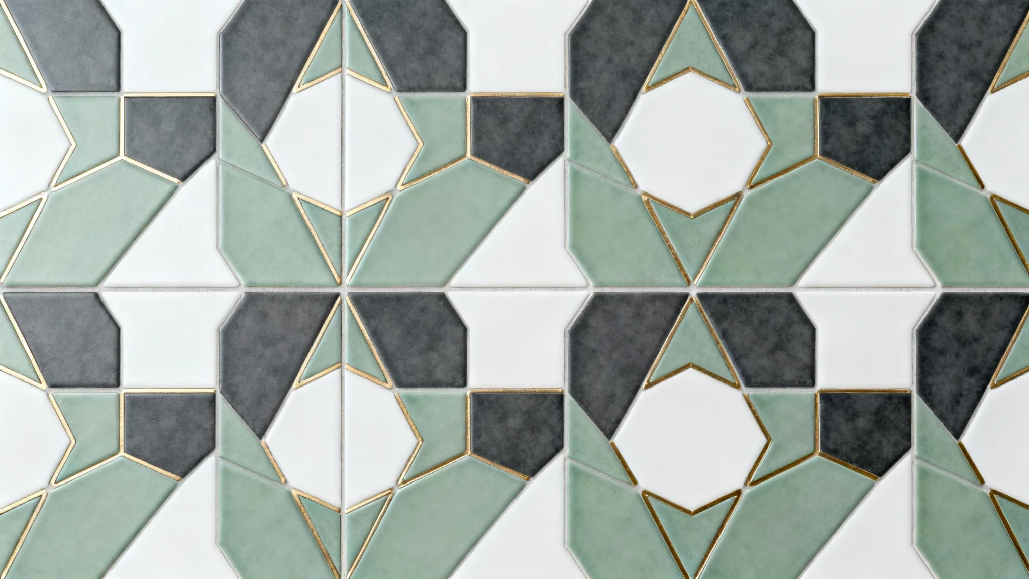 A flat lay image showcasing a modern, seamless geometric tile pattern with hexagonal and triangular shapes in sage green, charcoal gray, and white, accented with brass inlays, set against a plain white background.
