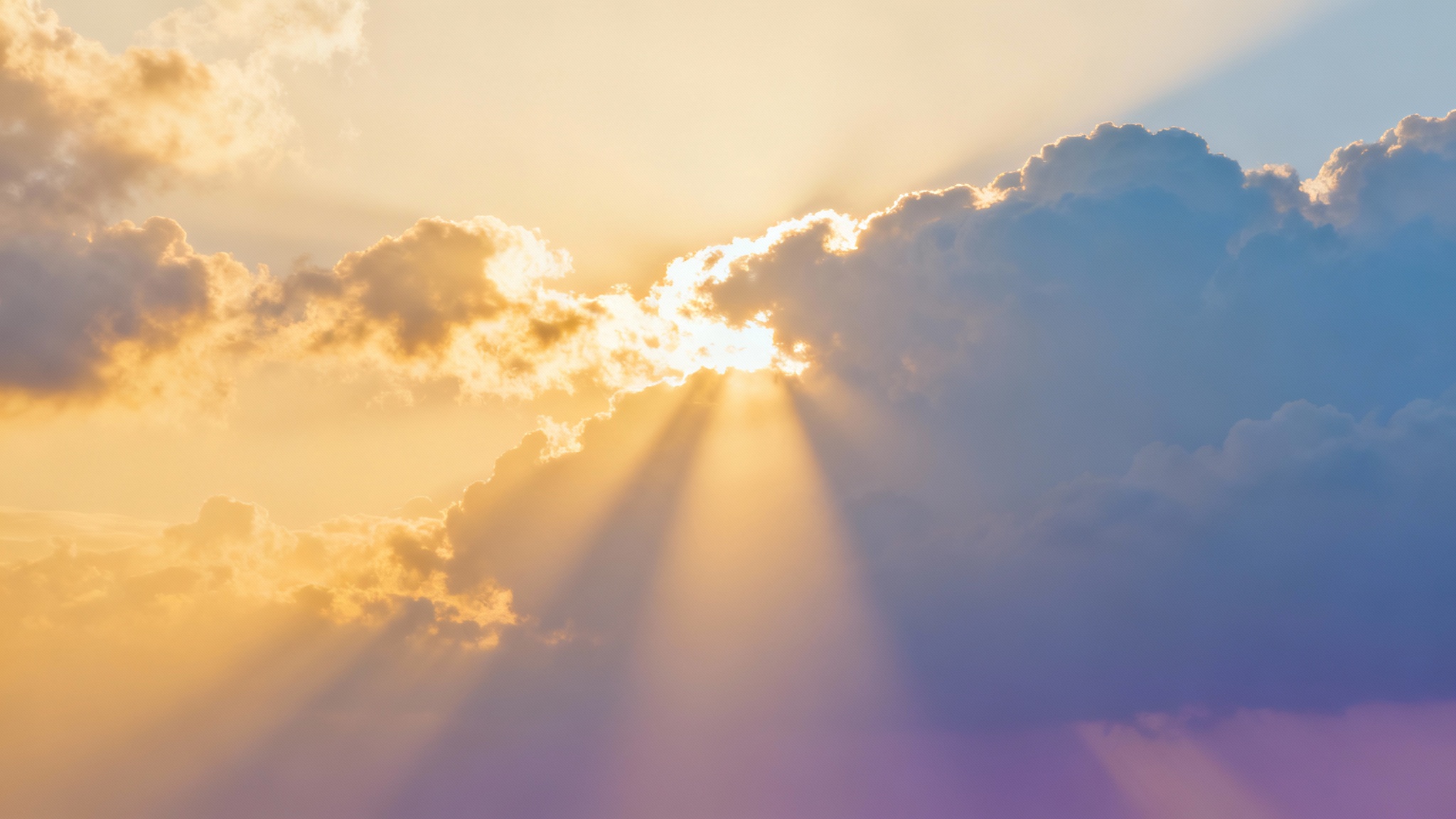 A serene sermon slide background showing golden sunbeams breaking through soft clouds in a blue and purple sky.
