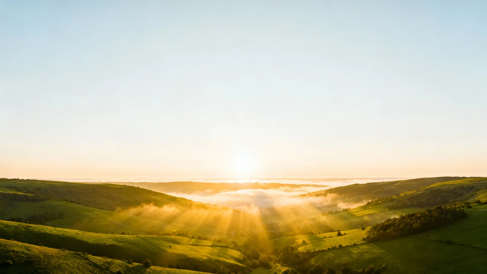 An inspiring sermon slide background featuring a sun-drenched valley with light rays breaking through the morning mist, creating a peaceful and hopeful atmosphere.