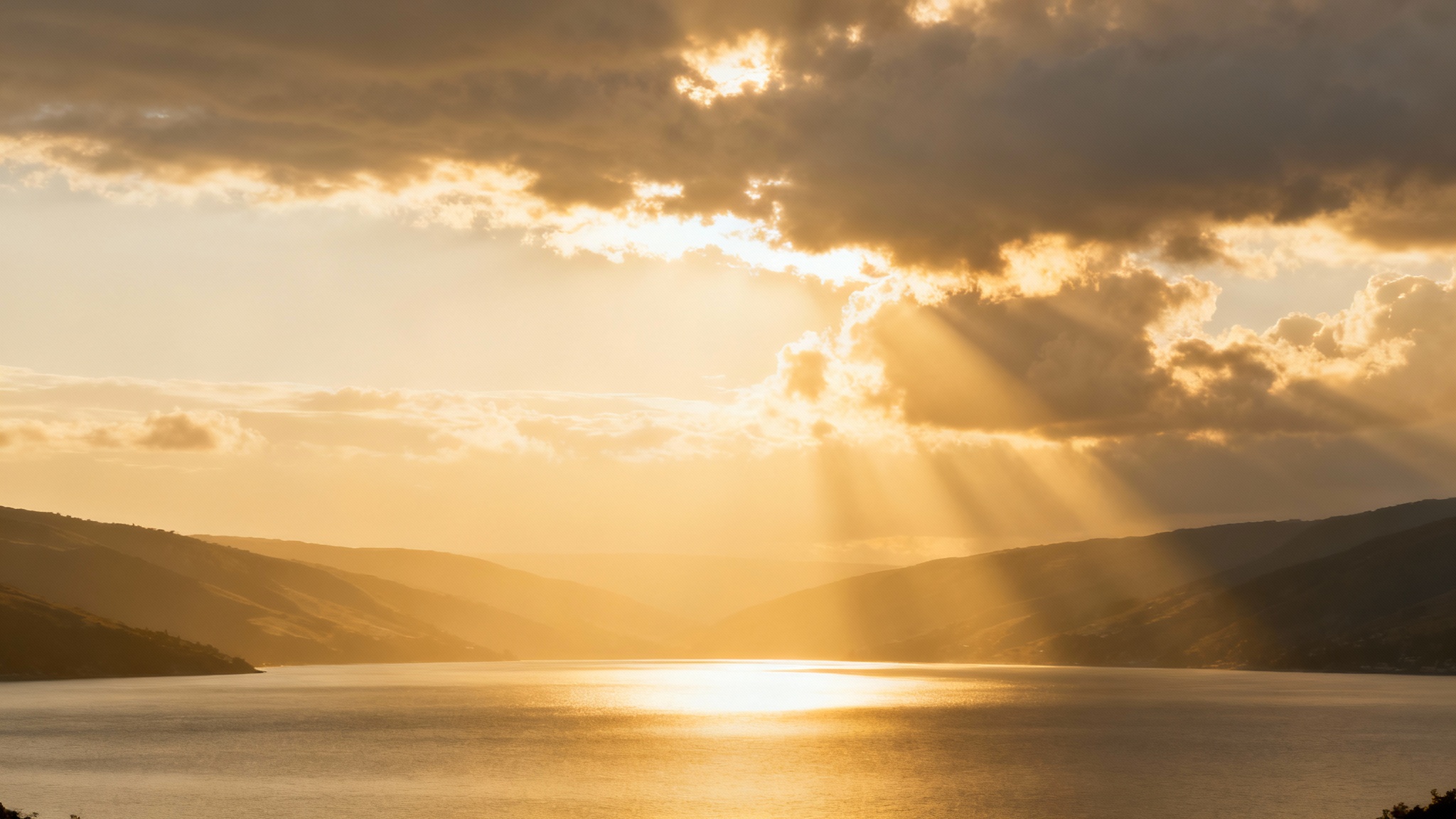 A mockup of a sermon slide background depicting heavenly golden light rays breaking through clouds over a peaceful landscape, set against a plain white background.