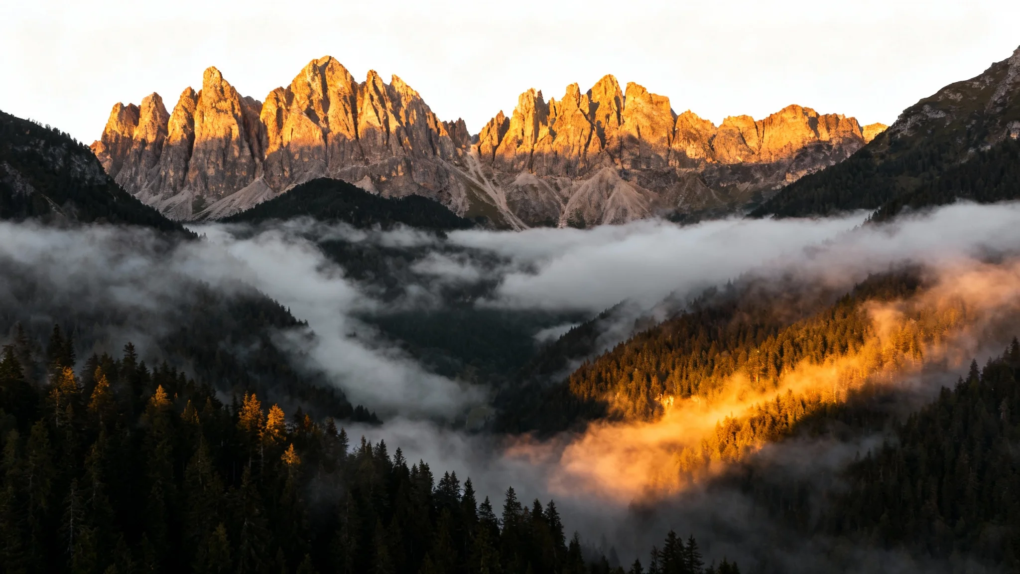 A stunning mountain landscape at sunrise, with a thick layer of mist filling the valley and swirling around the peaks, demonstrating an 'add mist' effect.