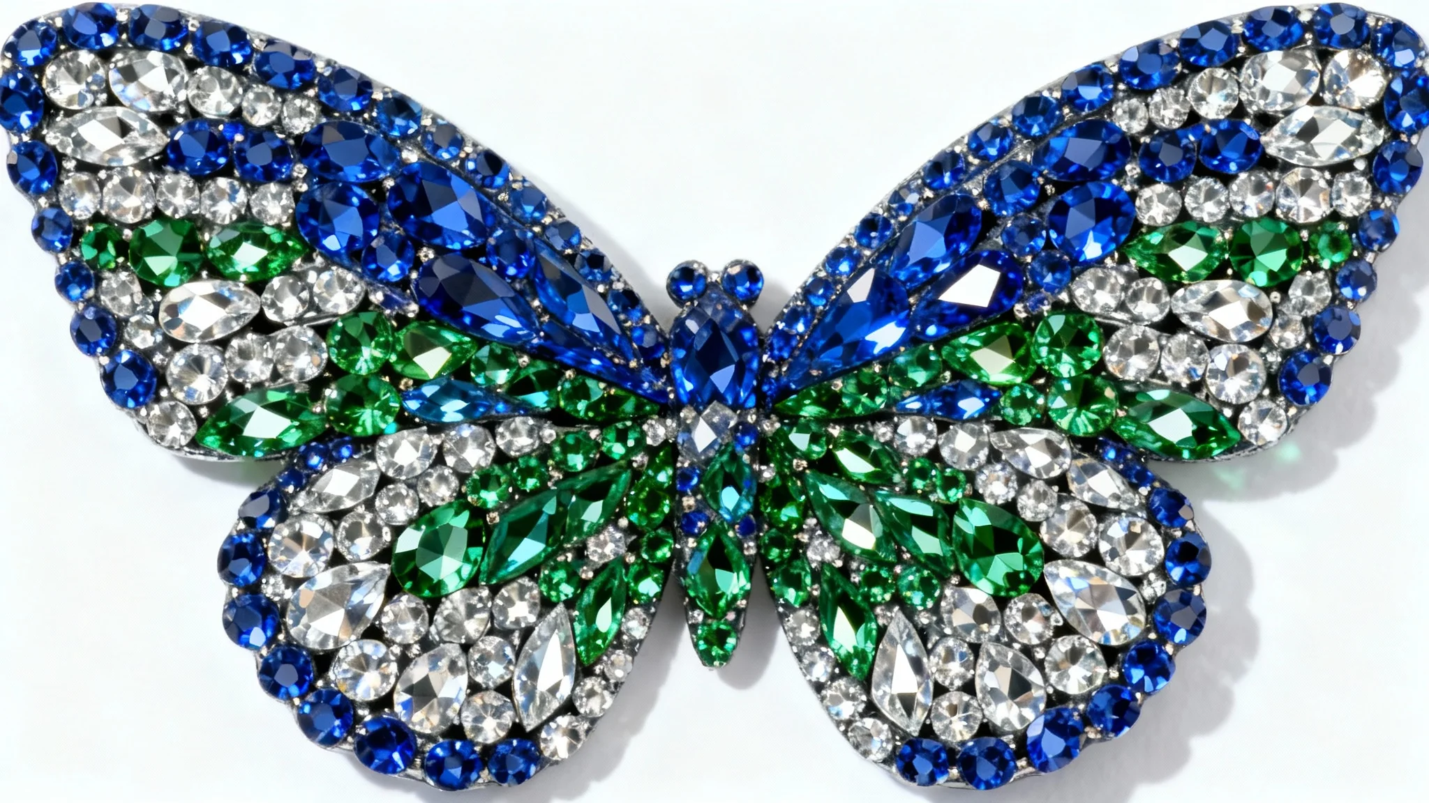 A hyper-detailed macro photograph of a butterfly pattern created with vibrant blue, green, and silver rhinestones, sparkling against a stark white background.