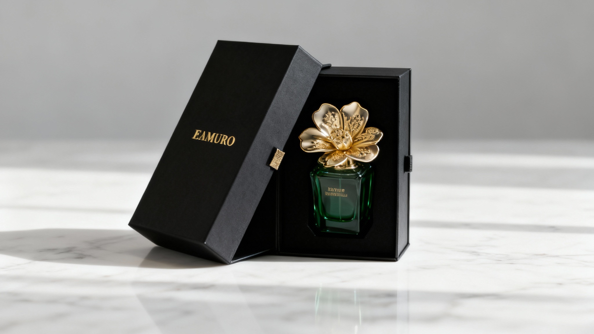 A professional mockup of a luxury perfume package, featuring a matte black and gold box and a flower-shaped bottle with green liquid, elegantly displayed on a marble surface in a minimalist studio setting.