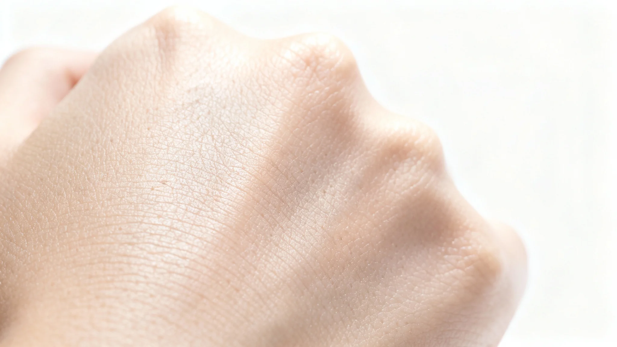 A hyper-realistic macro shot of healthy human skin, showcasing its fine texture, pores, and lines against a clean white background.